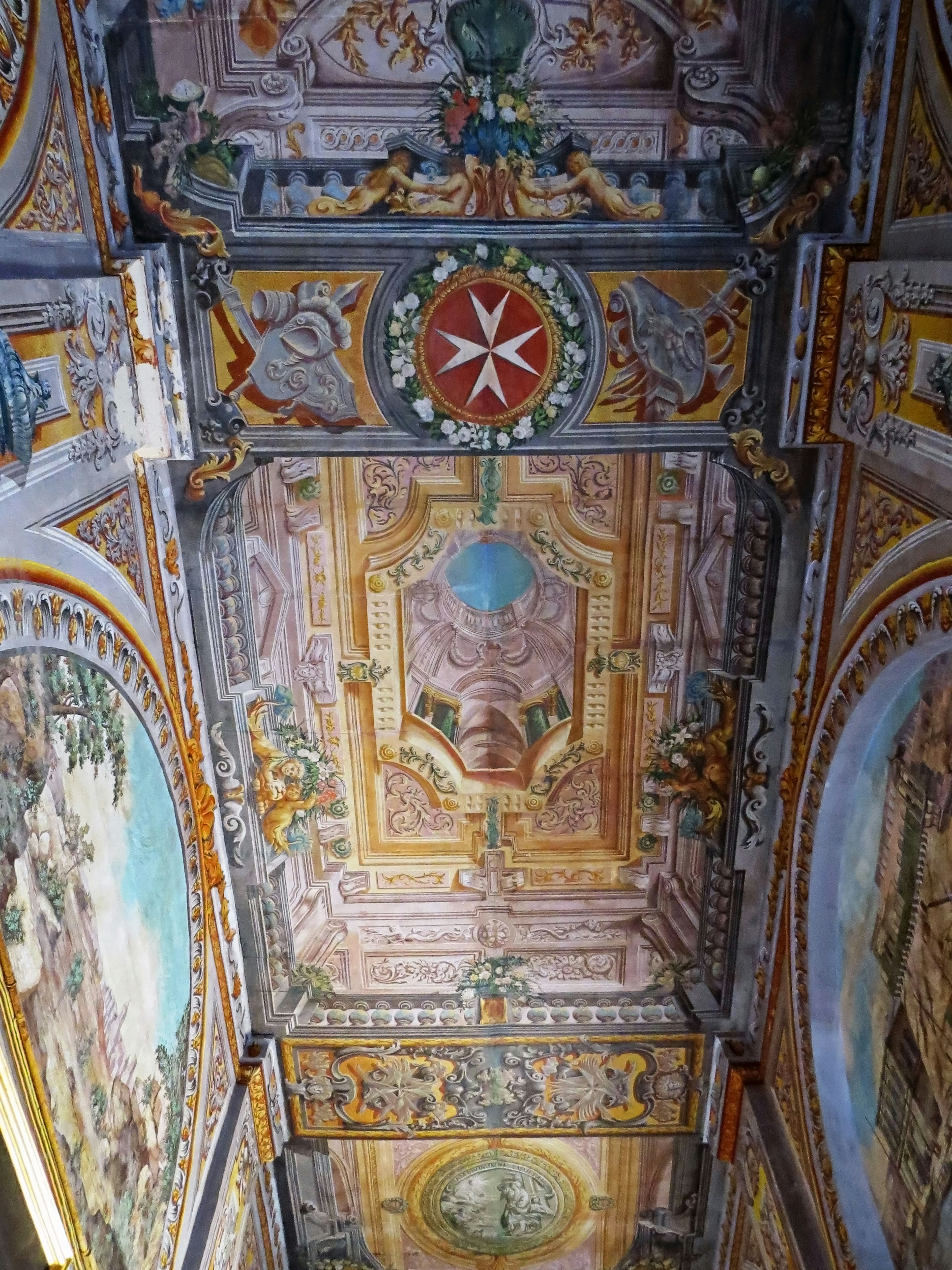 Image of a beautifully decorated ceiling with intricate frescoes and designs