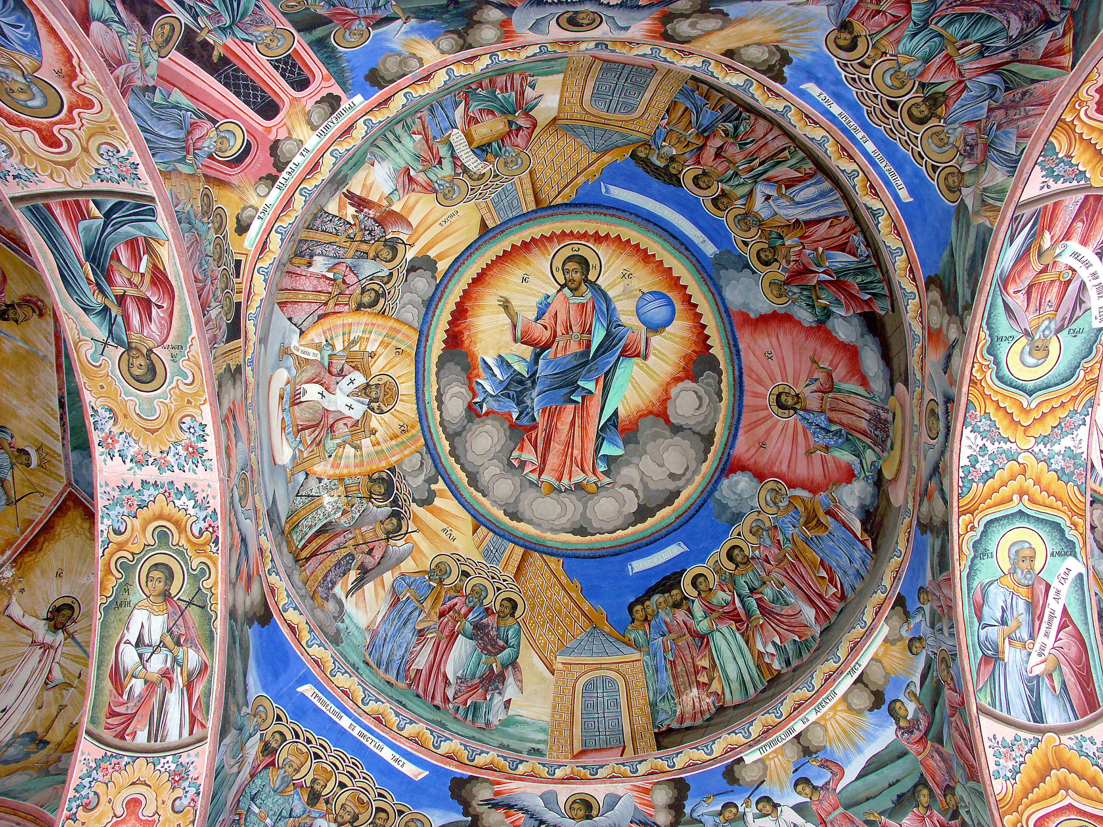 Vibrant ceiling fresco of a church featuring Christ at the center surrounded by images of saints