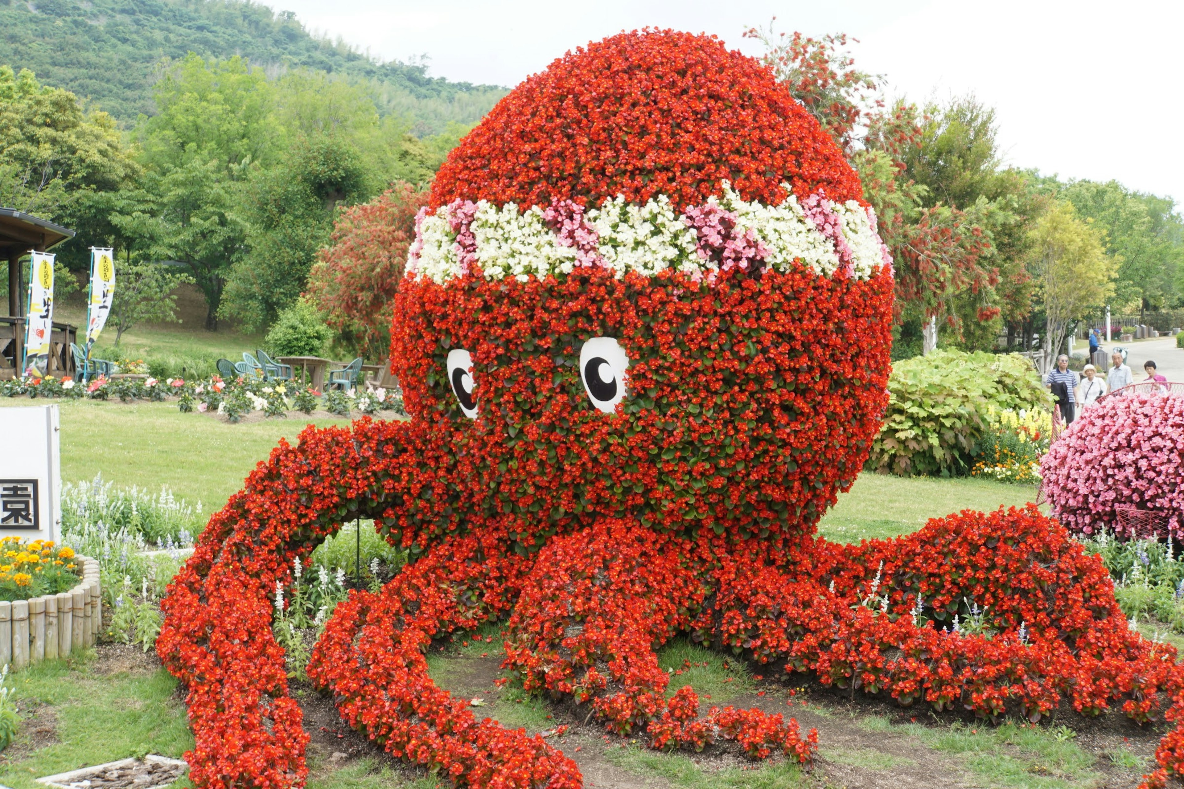 Large octopus sculpture made of red flowers