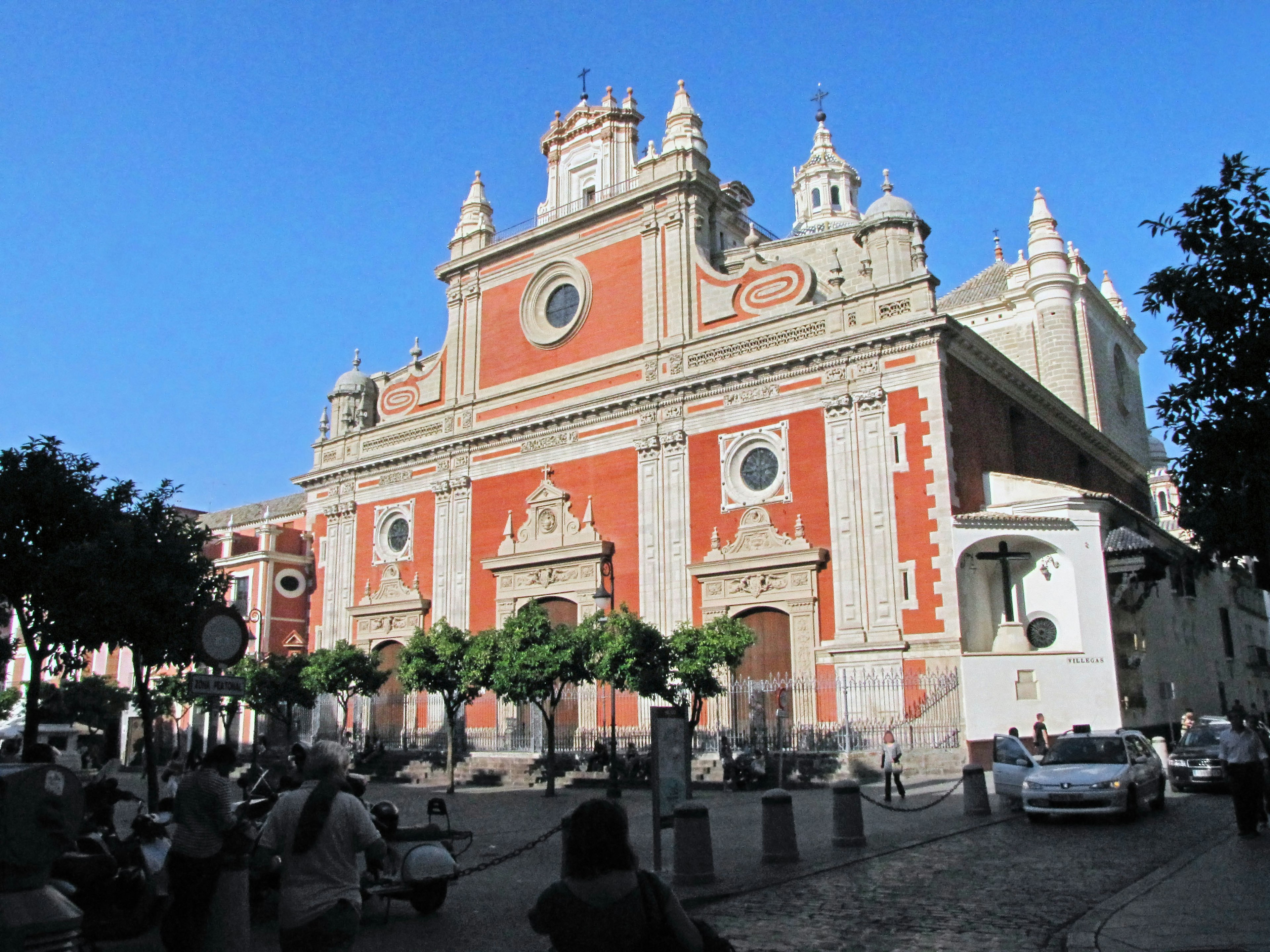 Exterior of a church featuring red walls and white decorations