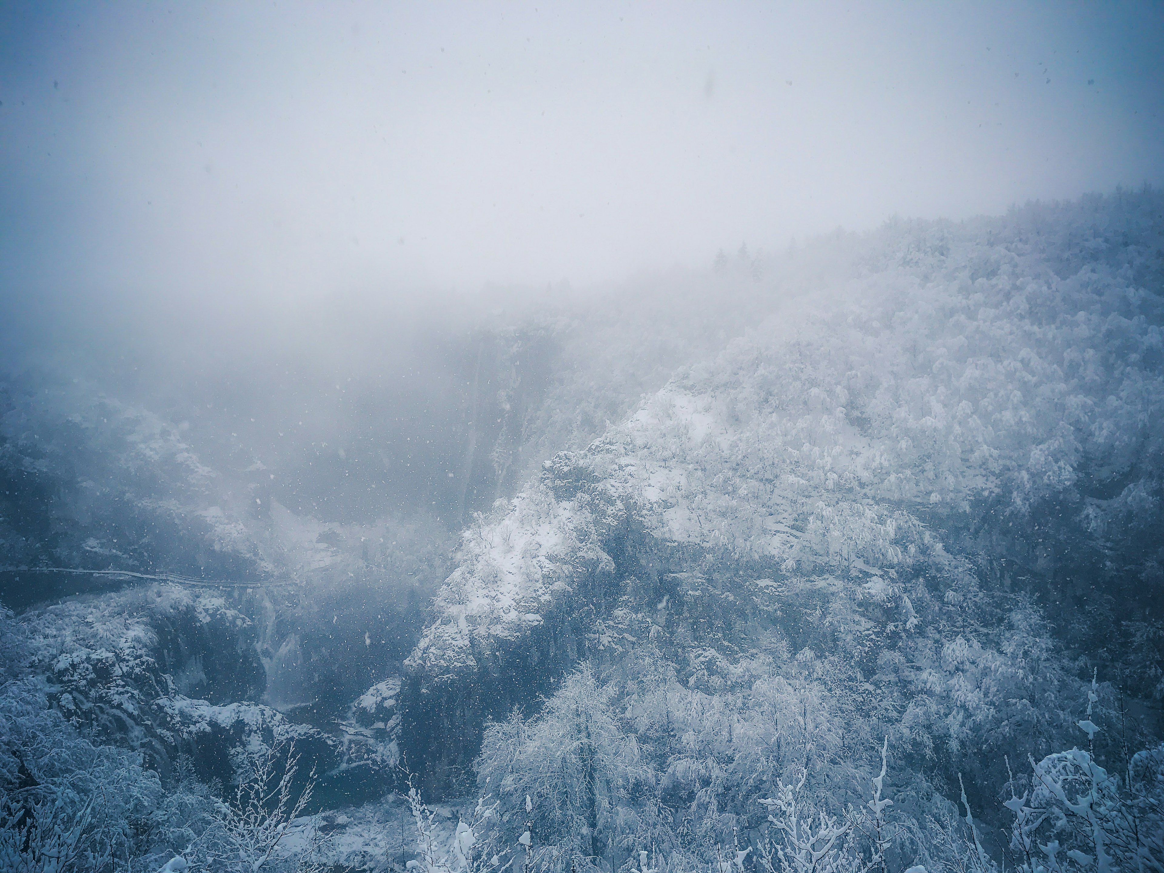 Foggy landscape of snow-covered mountains