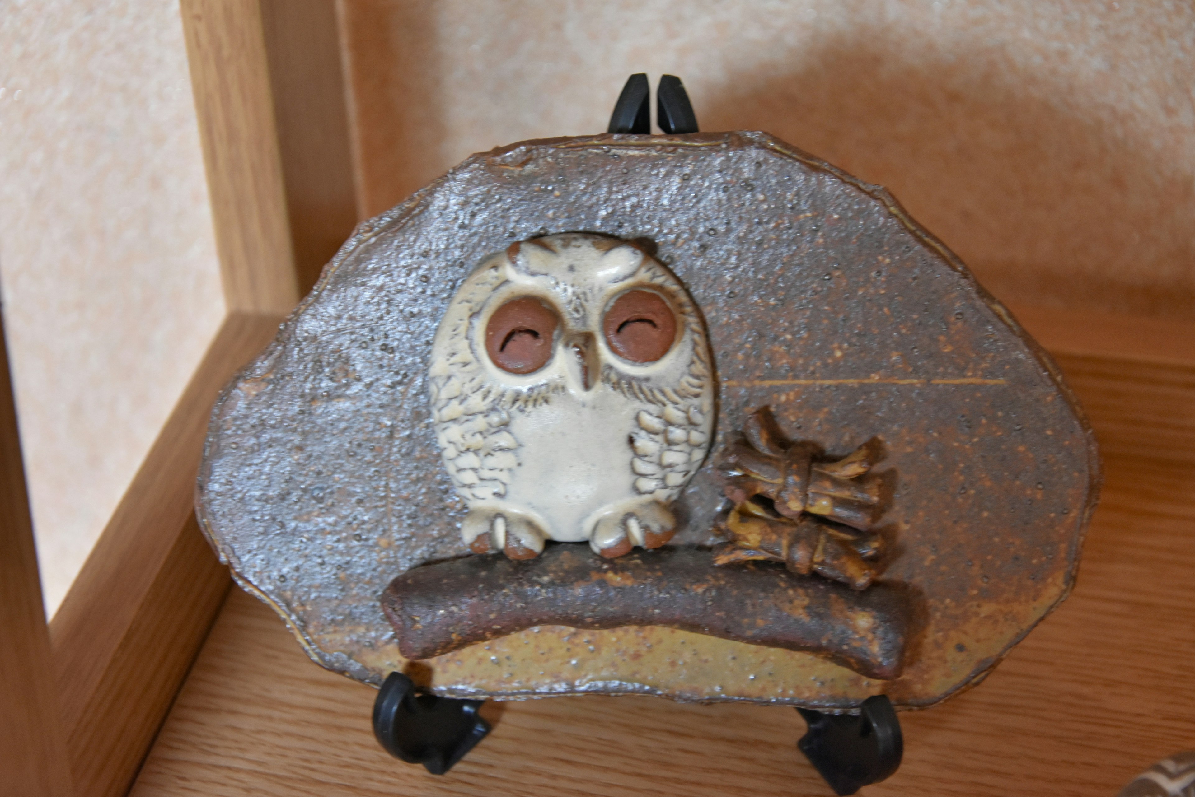 Decorative stone featuring an owl sculpture