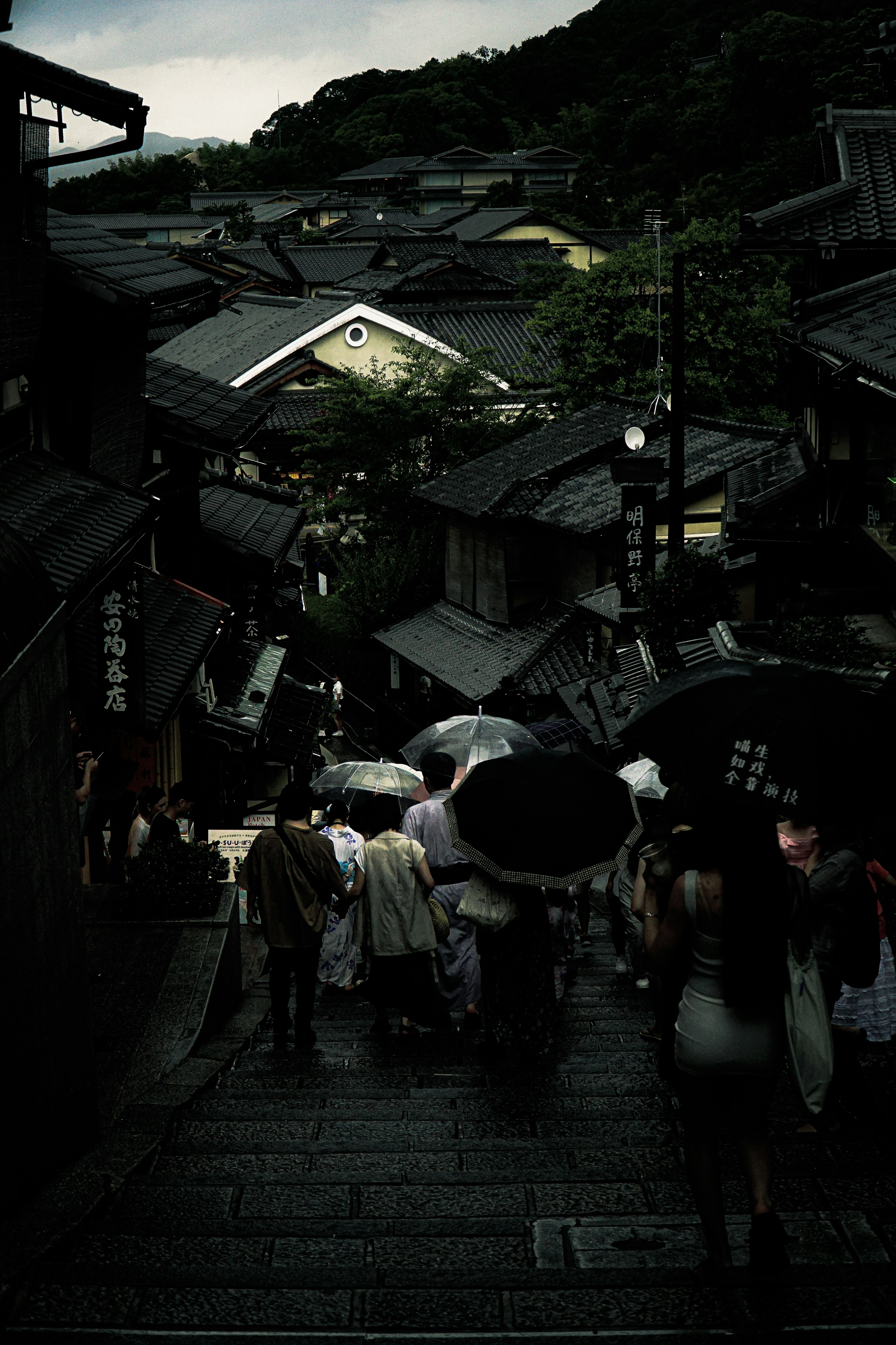 Historic streets with people under umbrellas in the rain