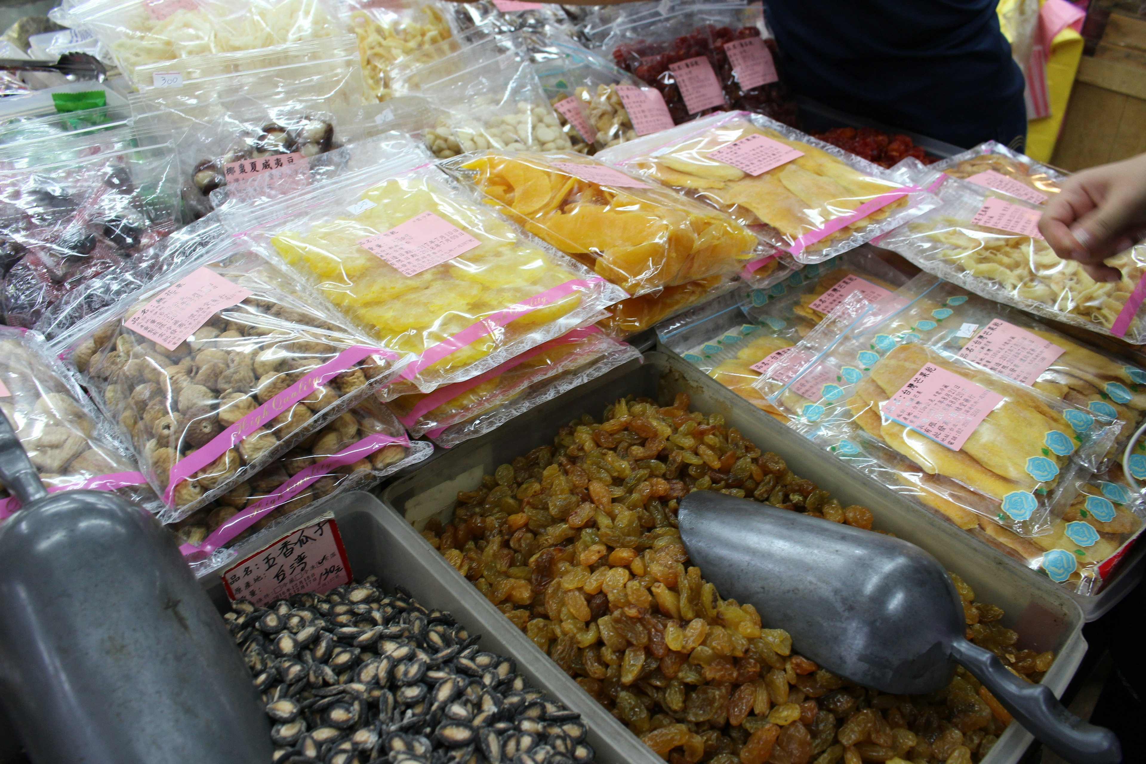 Colorful display of dried fruits and snacks at a market