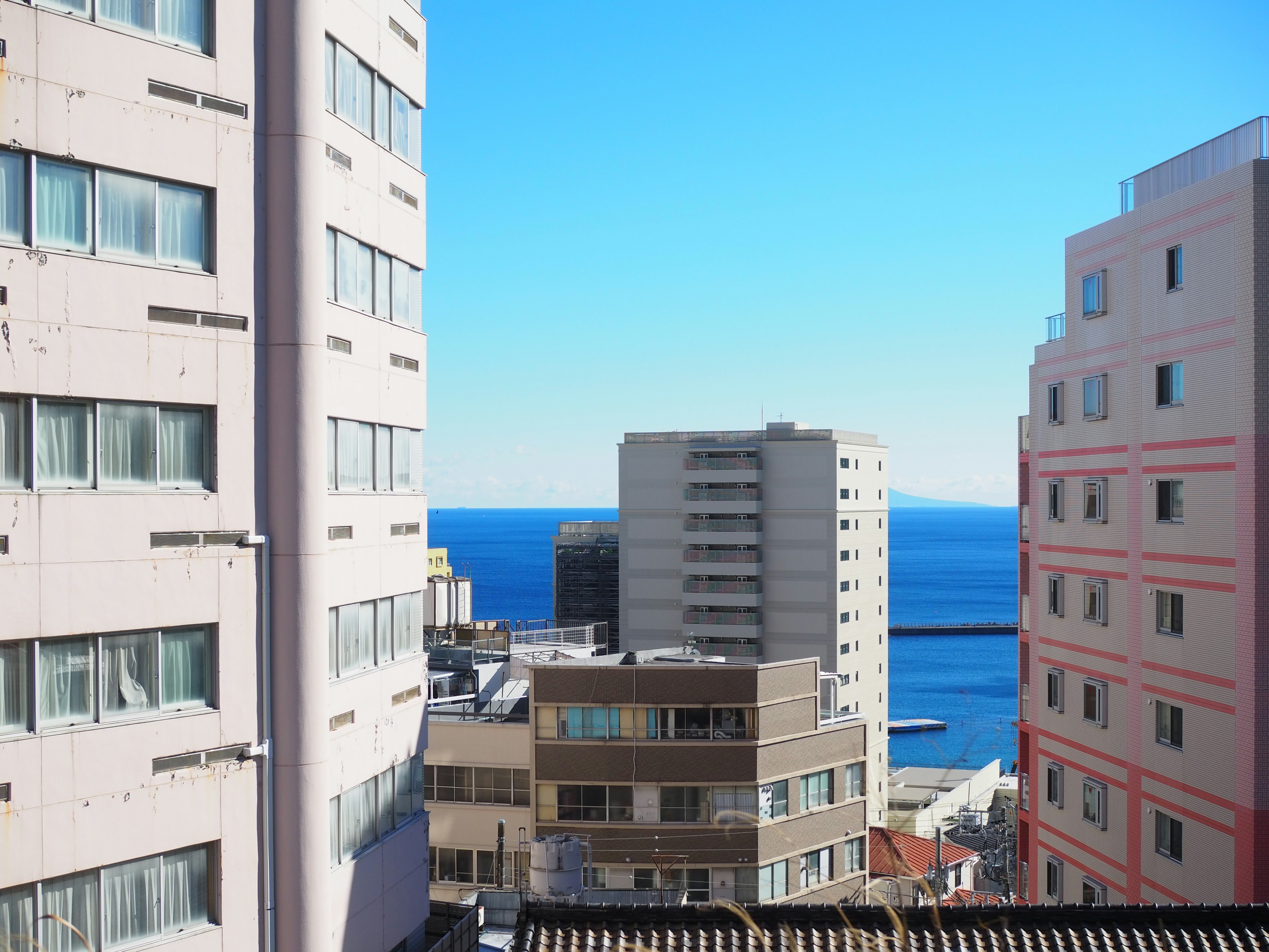 Urban view featuring blue sea and clear sky