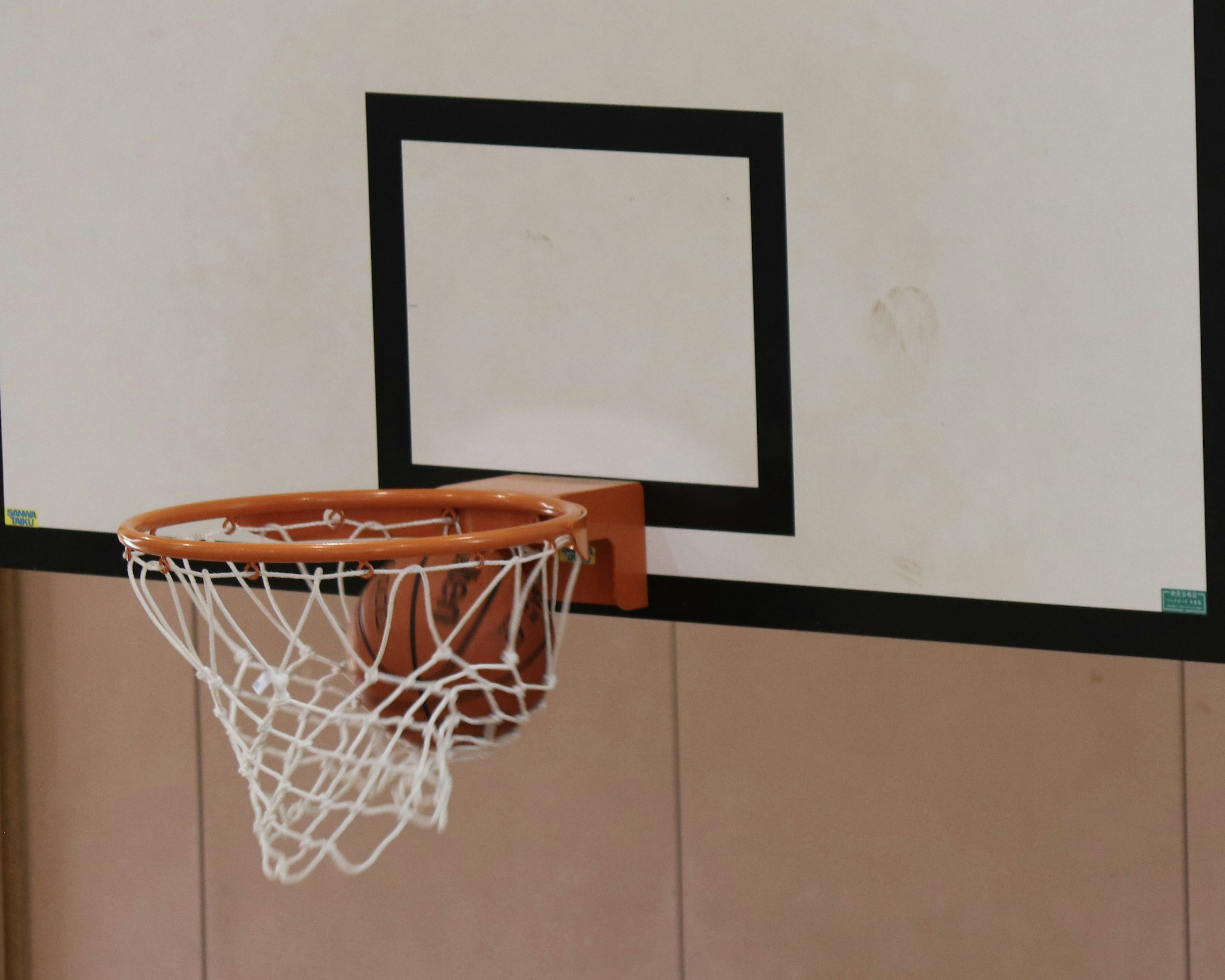 Basketball hoop and net in a gymnasium setting