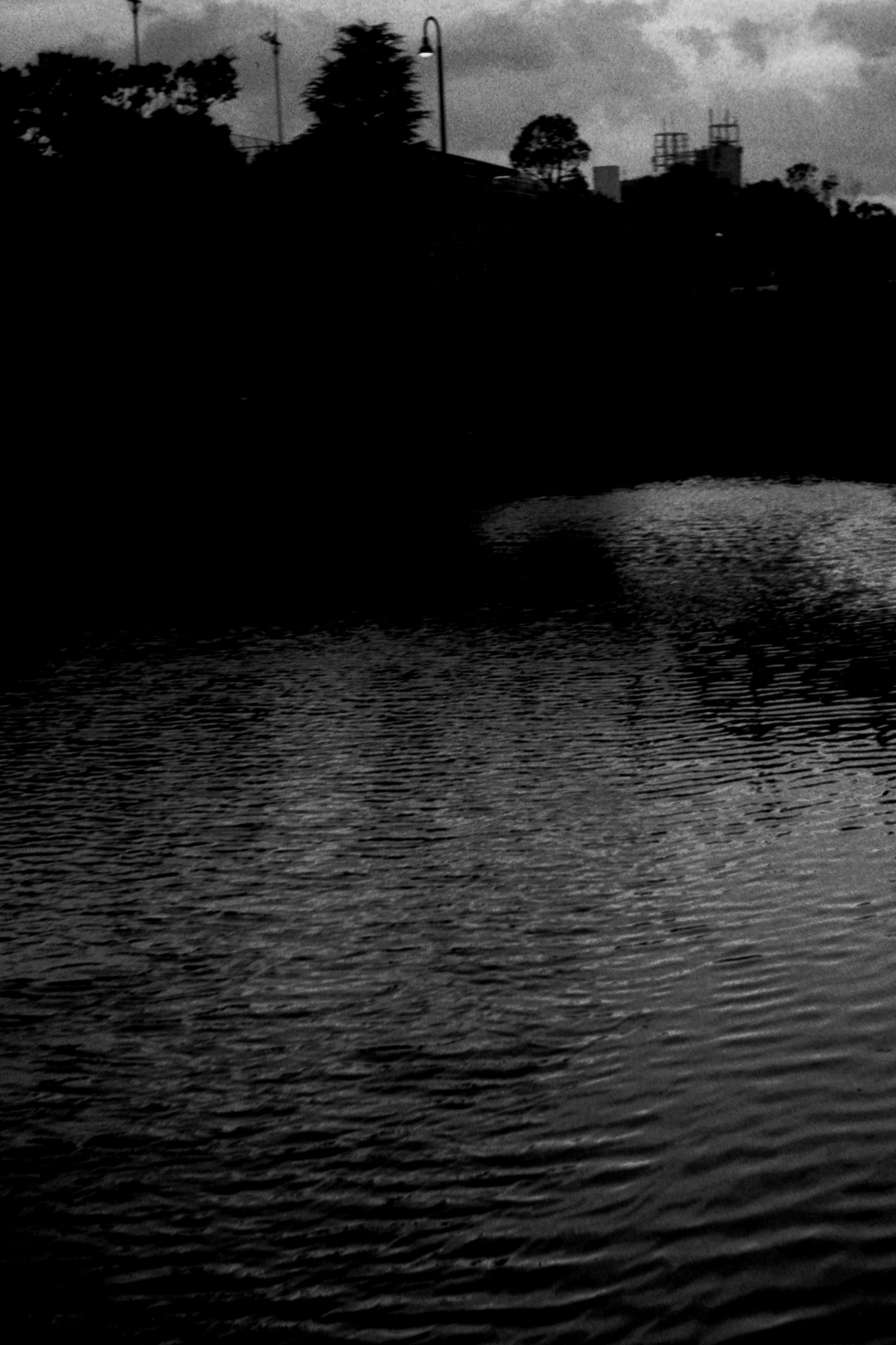 Dark water surface with shadowy landscape