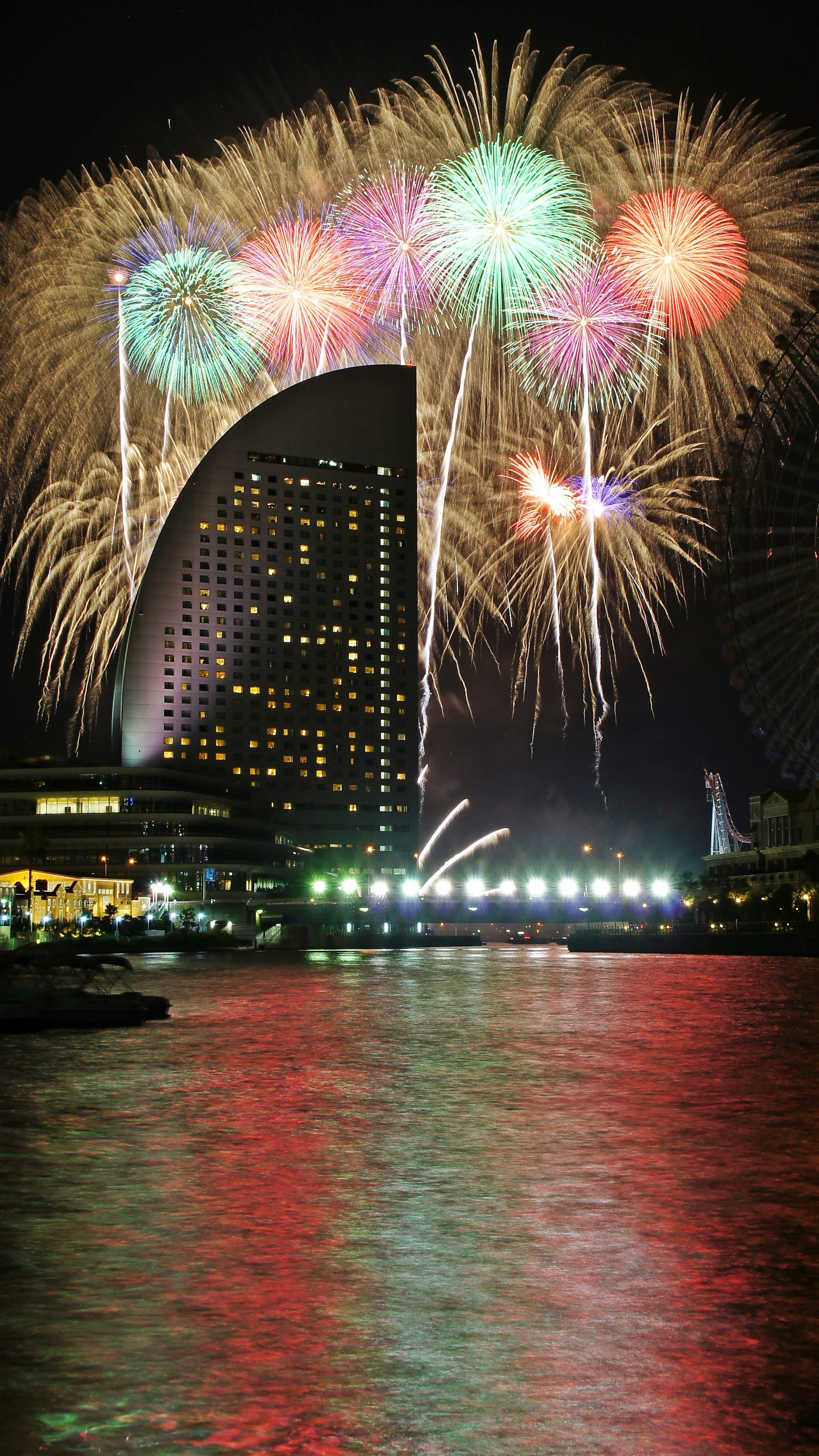 Colorful fireworks display over Yokohama skyline at night