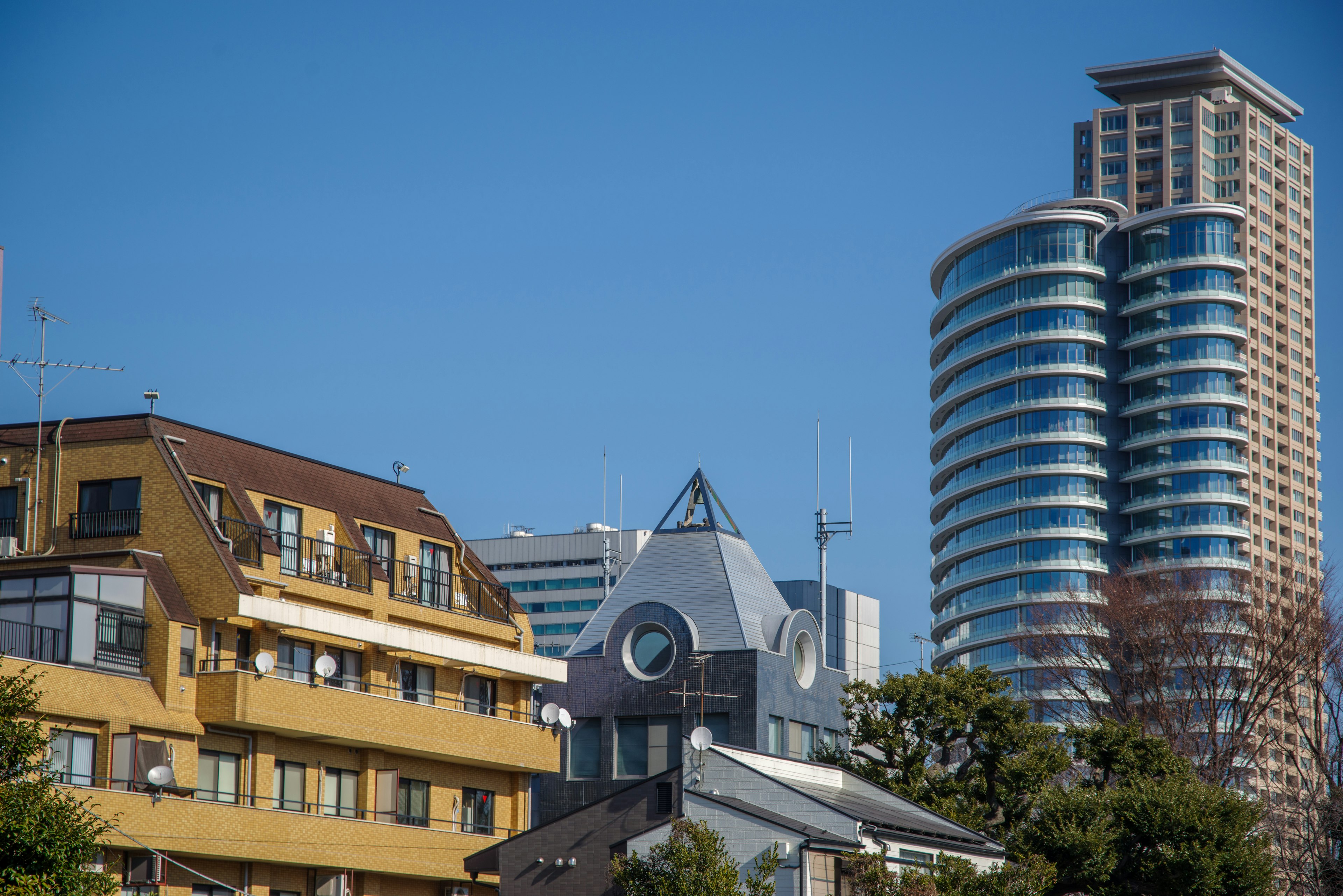 Cityscape featuring modern skyscrapers and traditional buildings