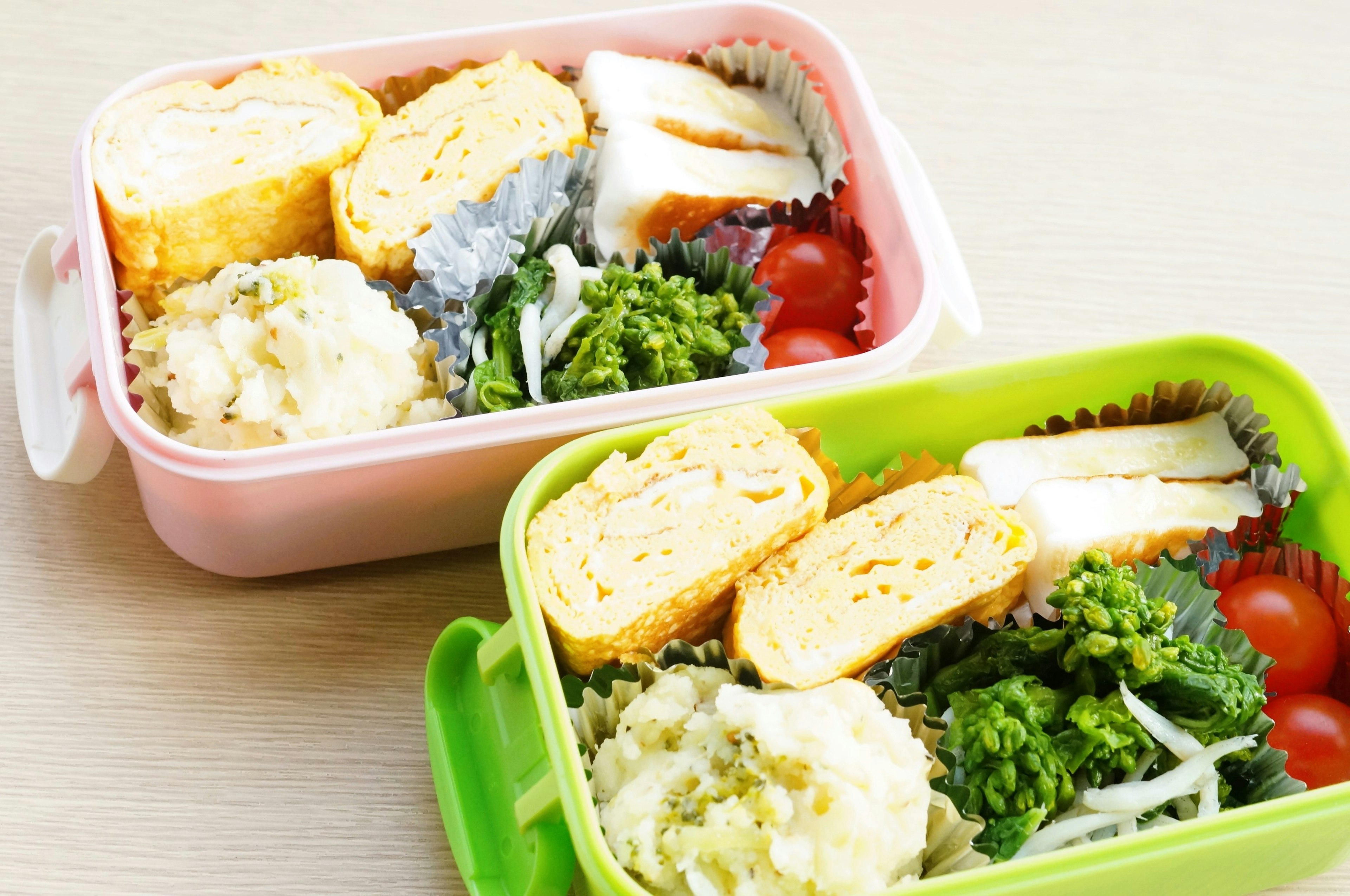 Colorful bento boxes filled with Japanese cuisine