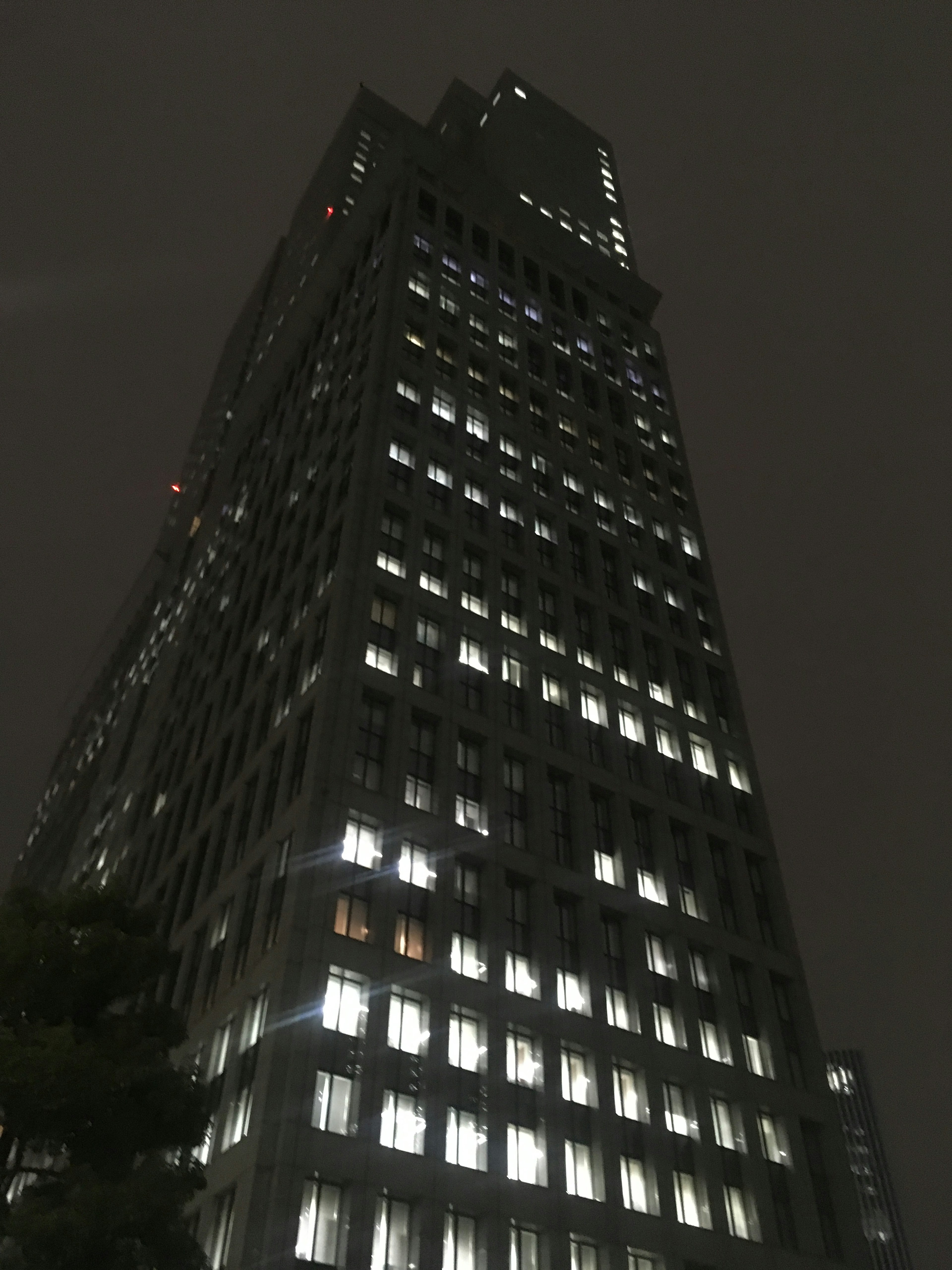 Tall building illuminated at night with visible windows