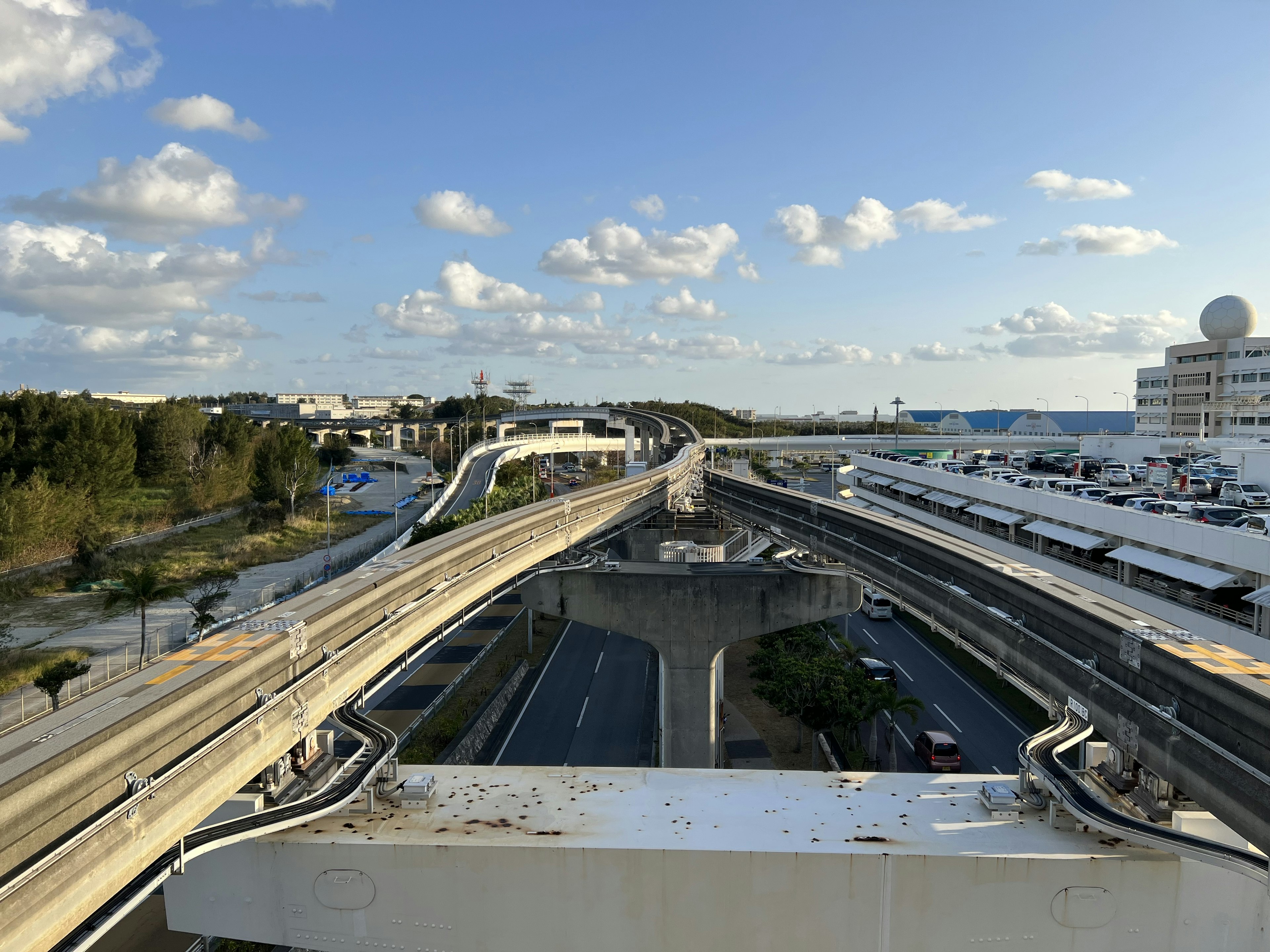 A view of elevated highways and blue sky with visible traffic flow