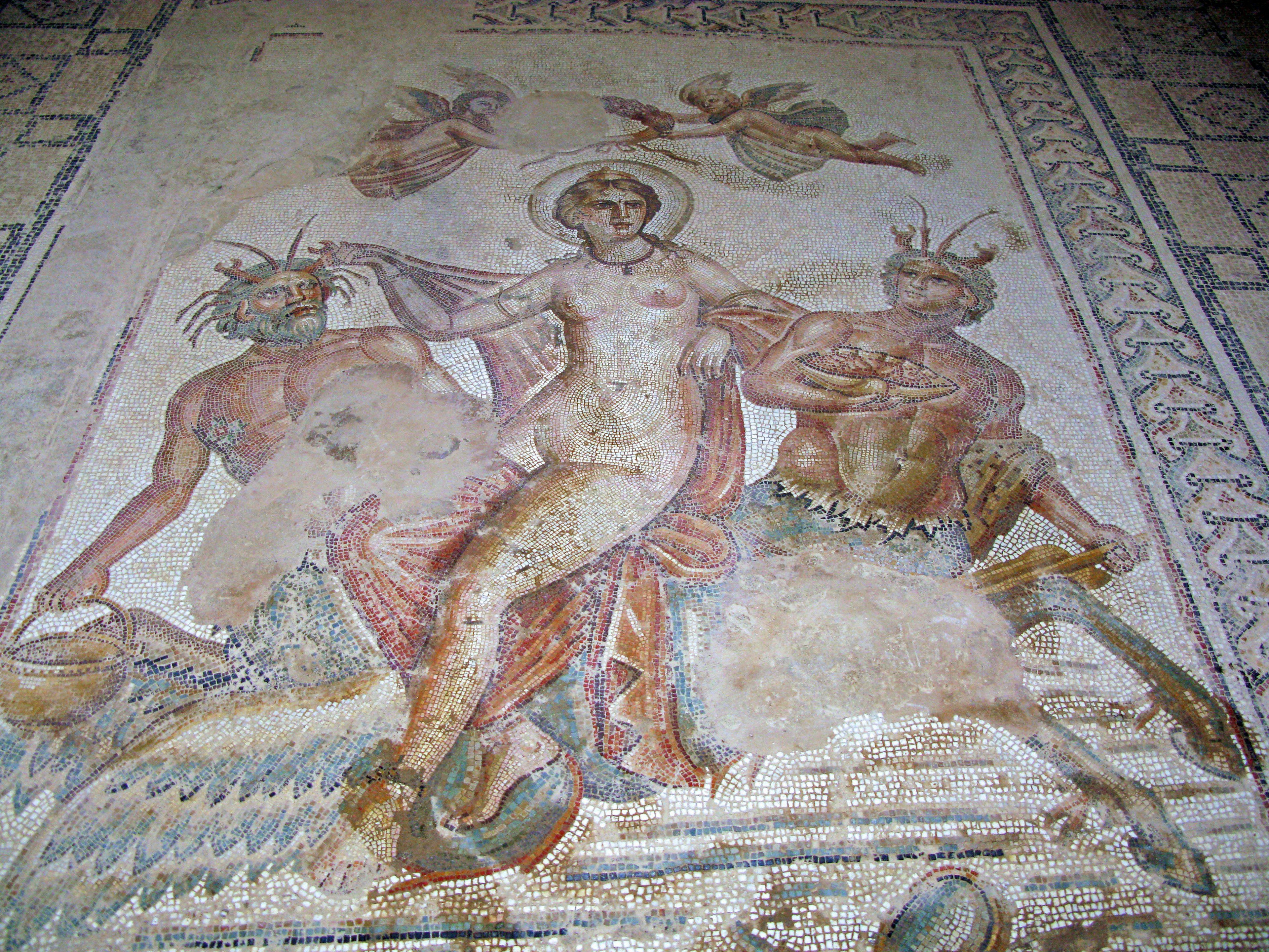 Ancient mosaic depicting a goddess with two male figures