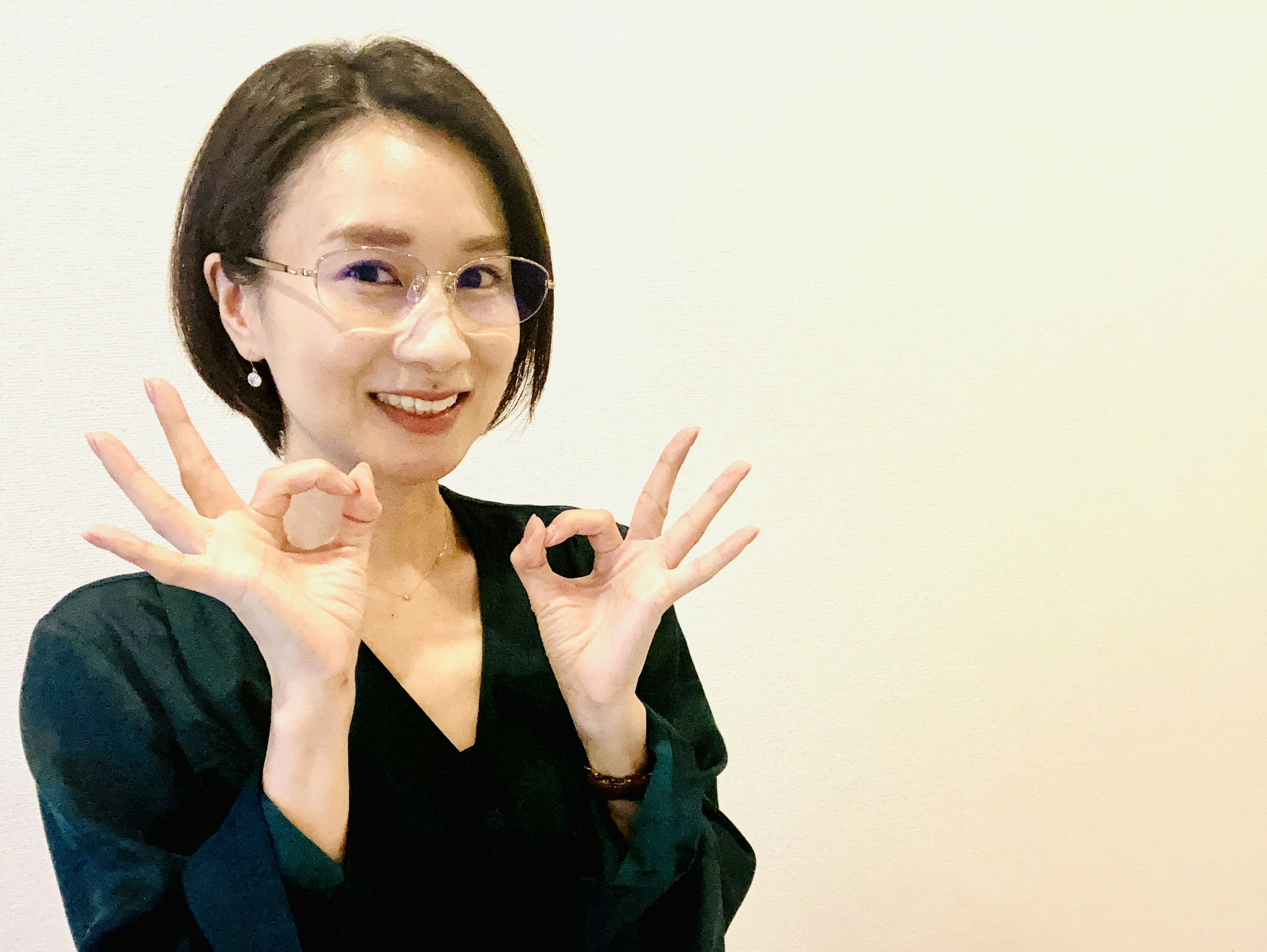 Woman smiling while holding two rings