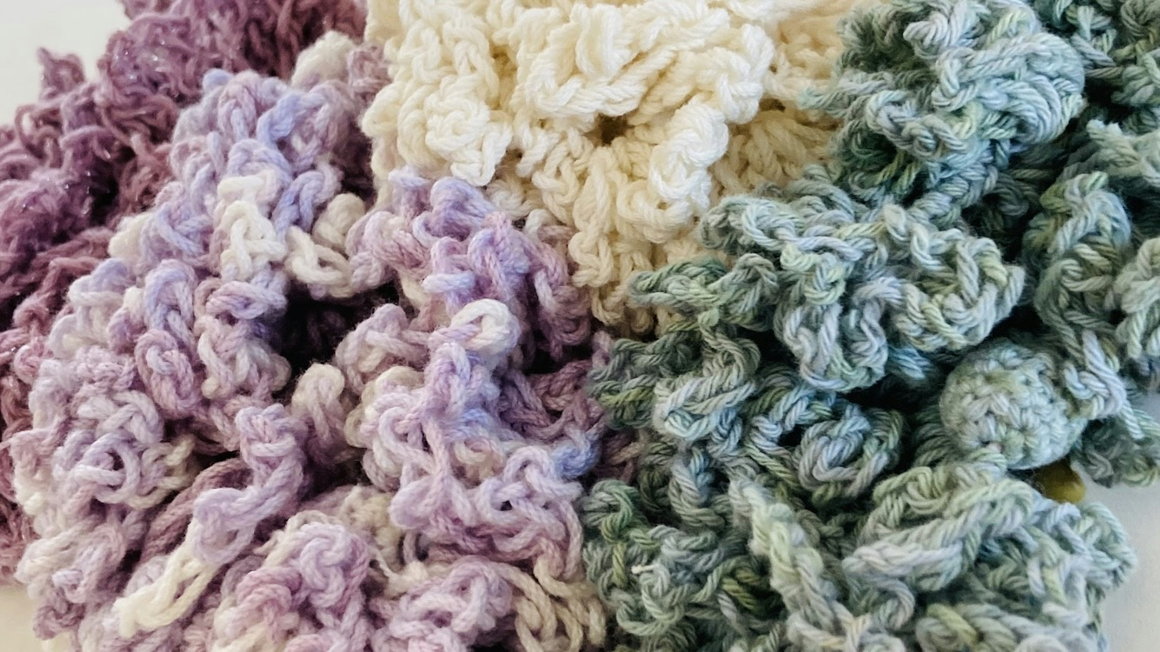 Soft textured yarn pieces in shades of purple and green