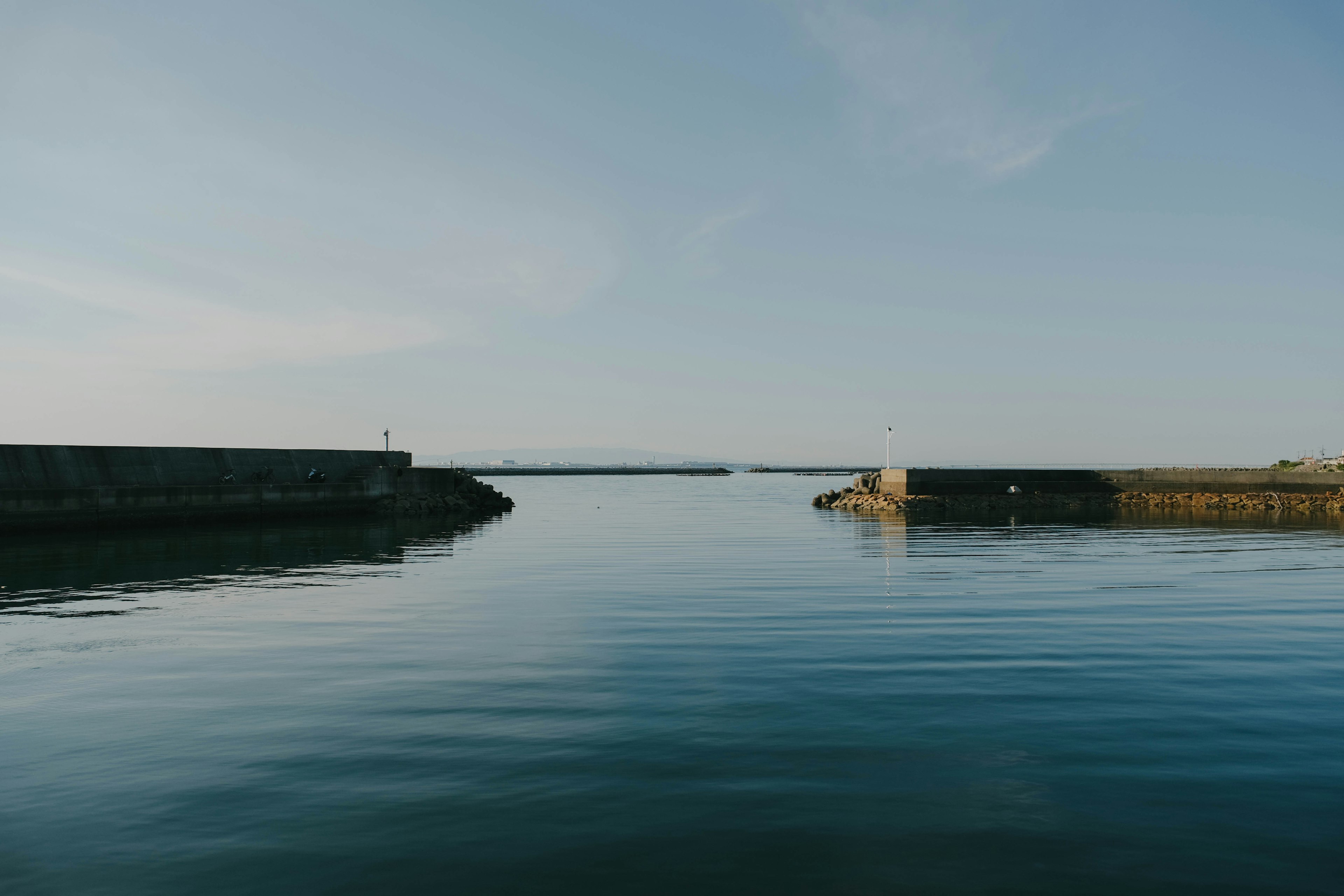 Calm harbor water surface under blue sky