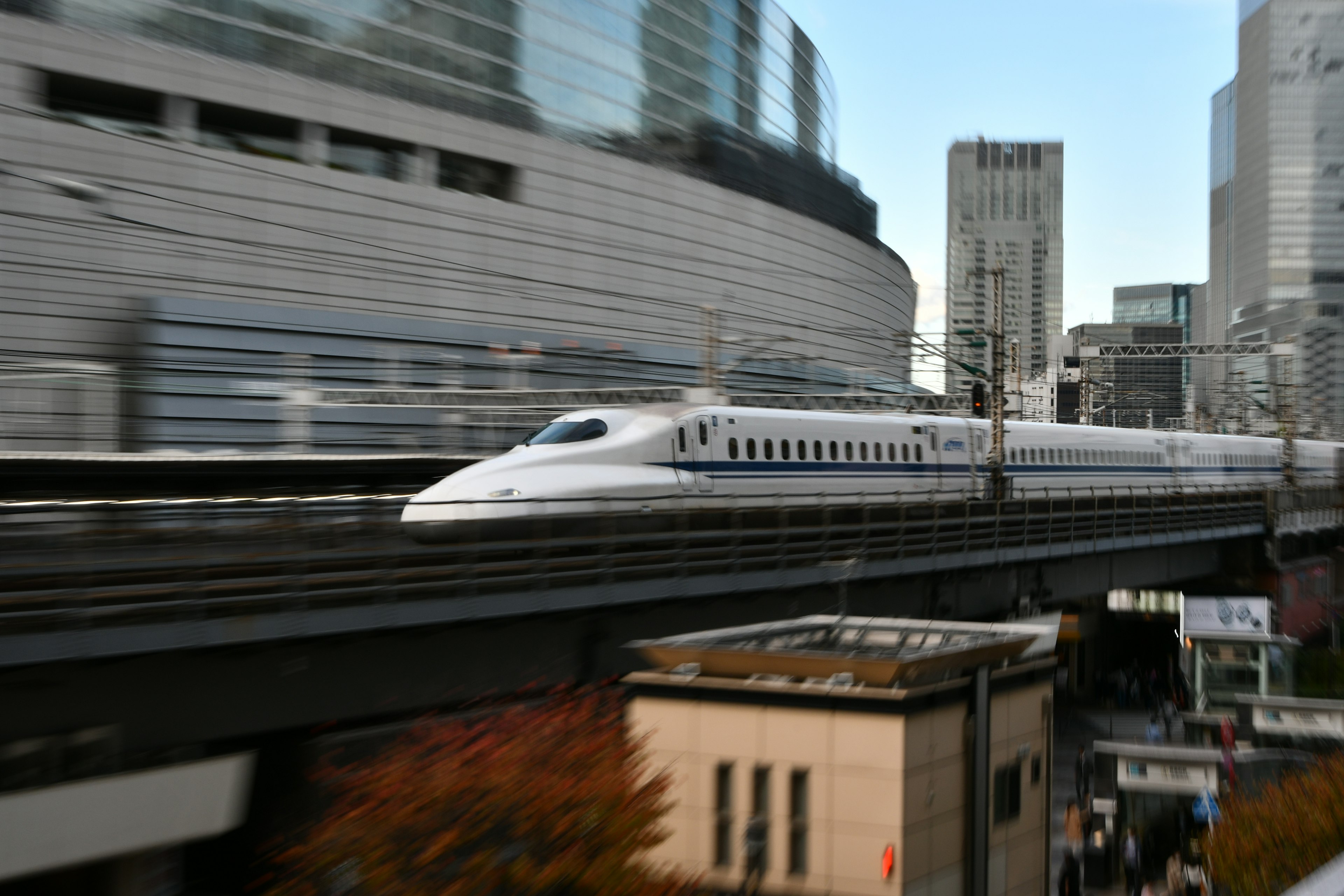 Shinkansen train speeding through an urban landscape