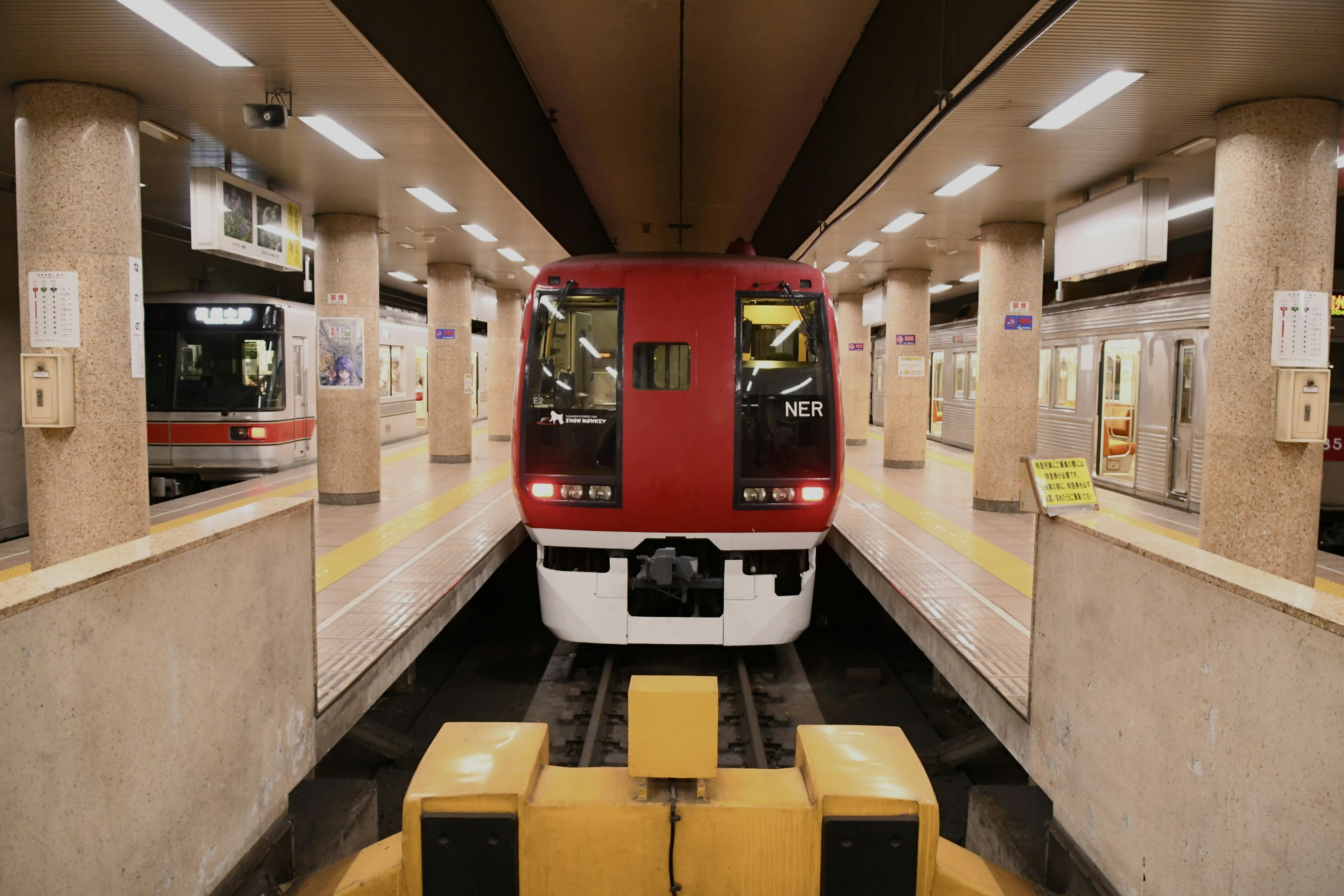 Kereta merah berhenti di platform stasiun kereta bawah tanah