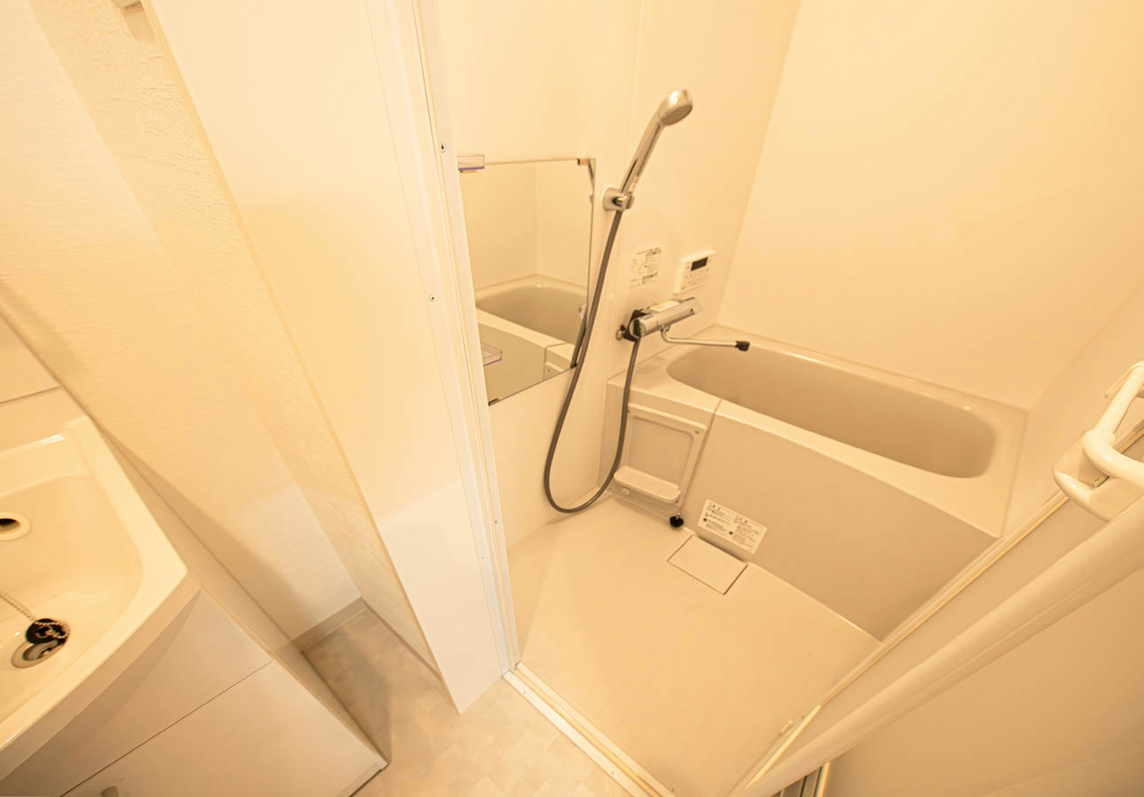 Brightly lit bathroom featuring a bathtub and shower