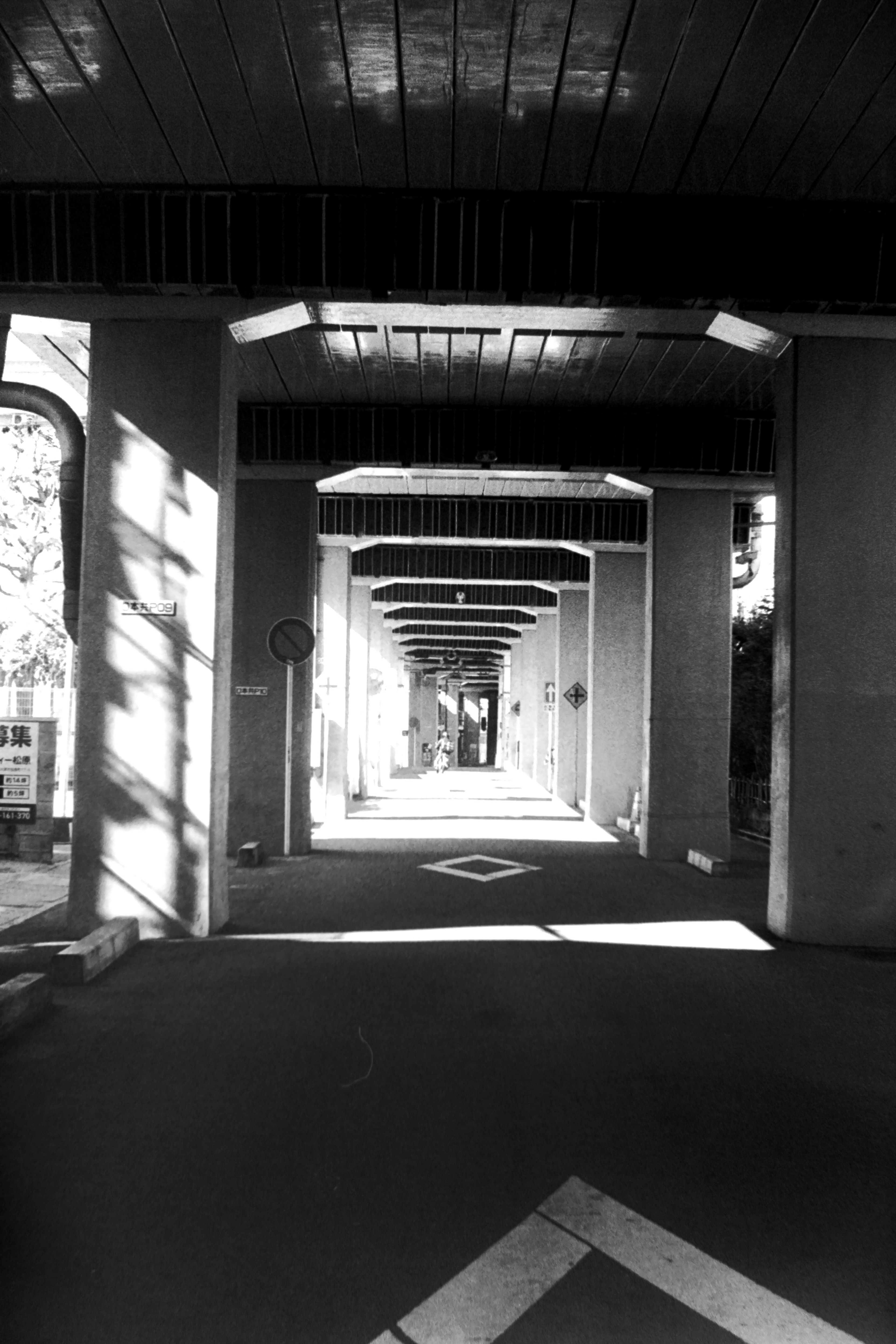 Black and white arcade hallway with a deep perspective