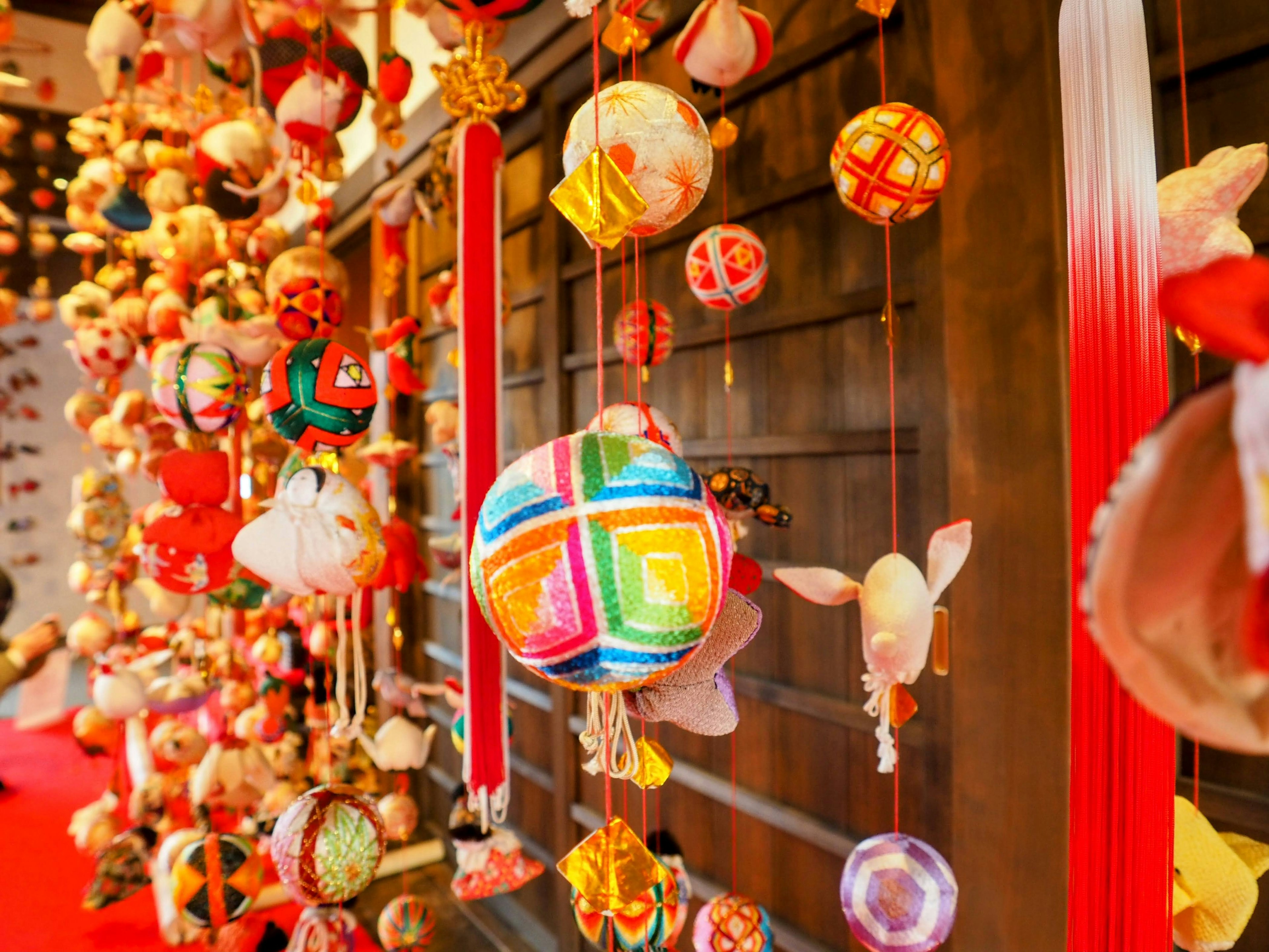 Colorful decorative balls hanging in a traditional Japanese display