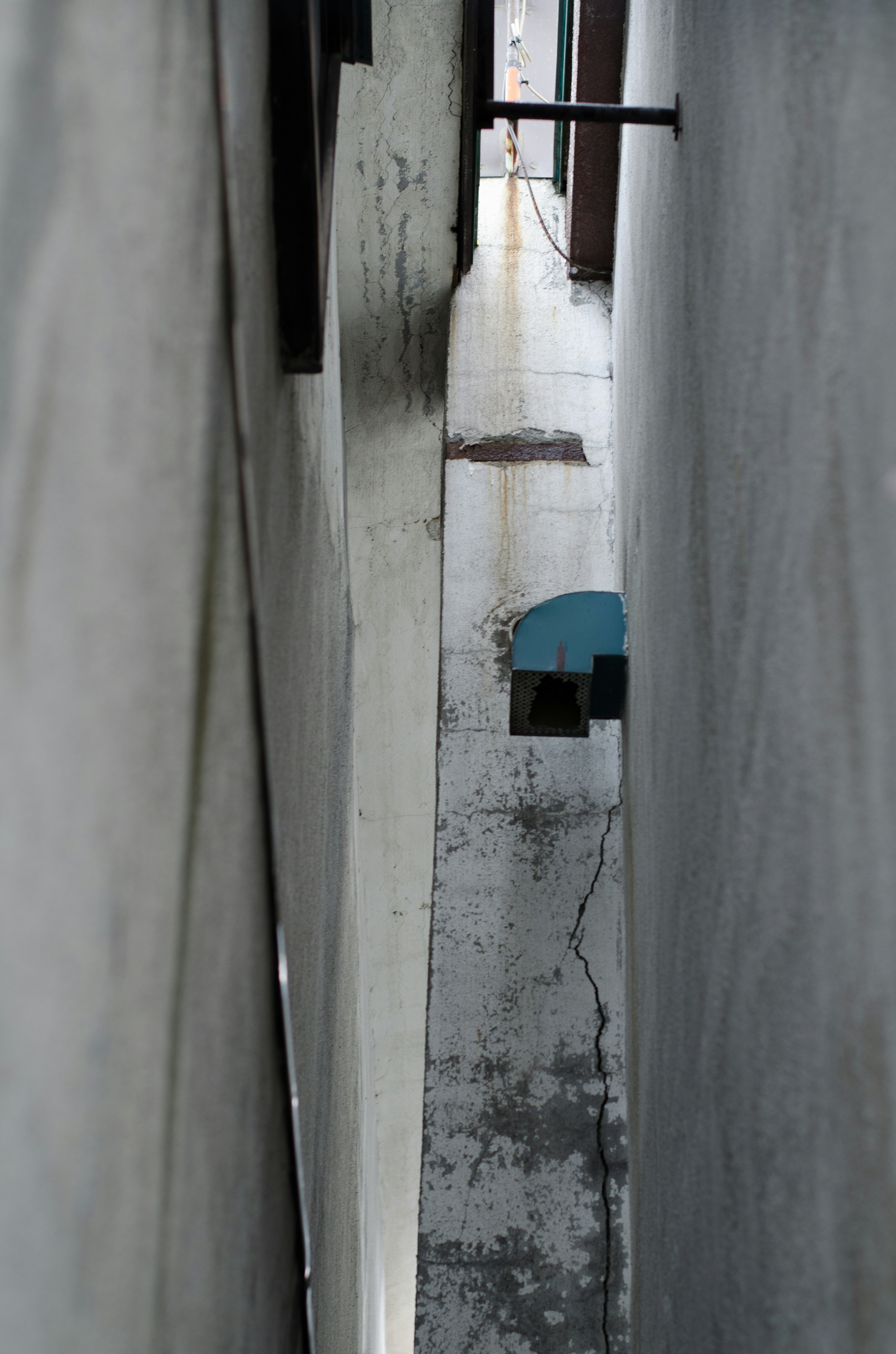 Schmale Gasse mit einem sichtbaren blauen Stuhl