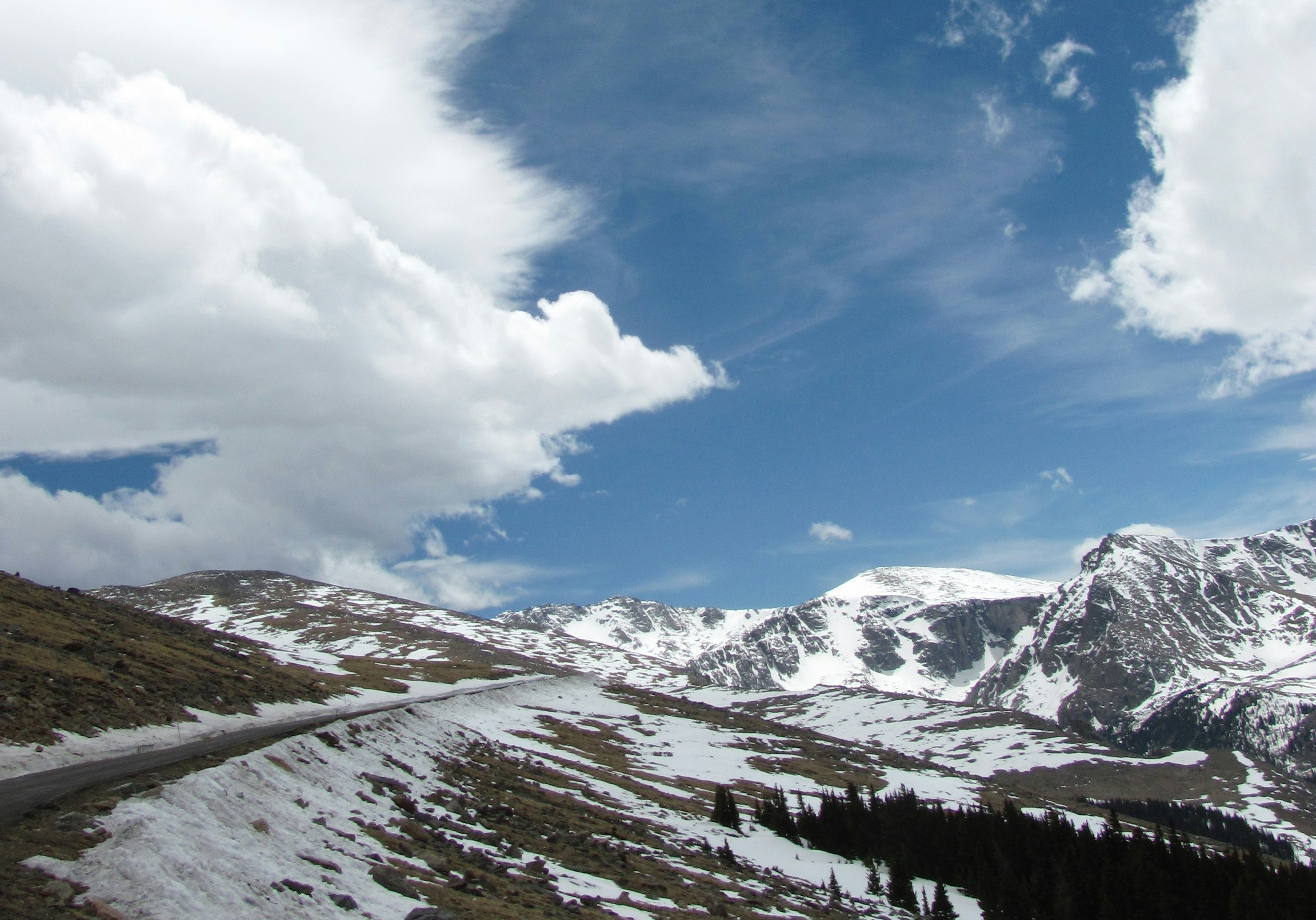 Snow-covered mountains with a blue sky