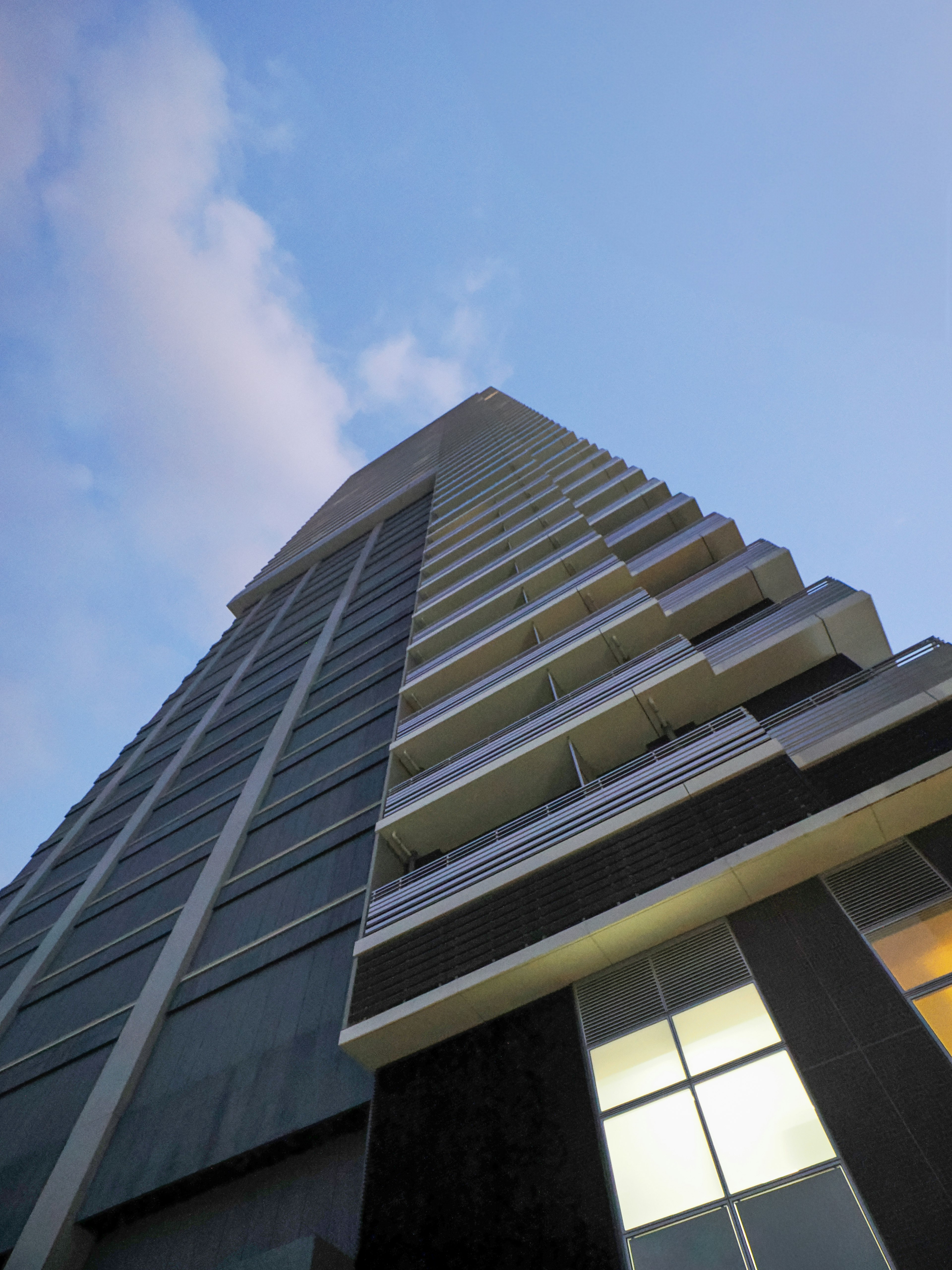 Skyscraper viewed from below against a blue sky