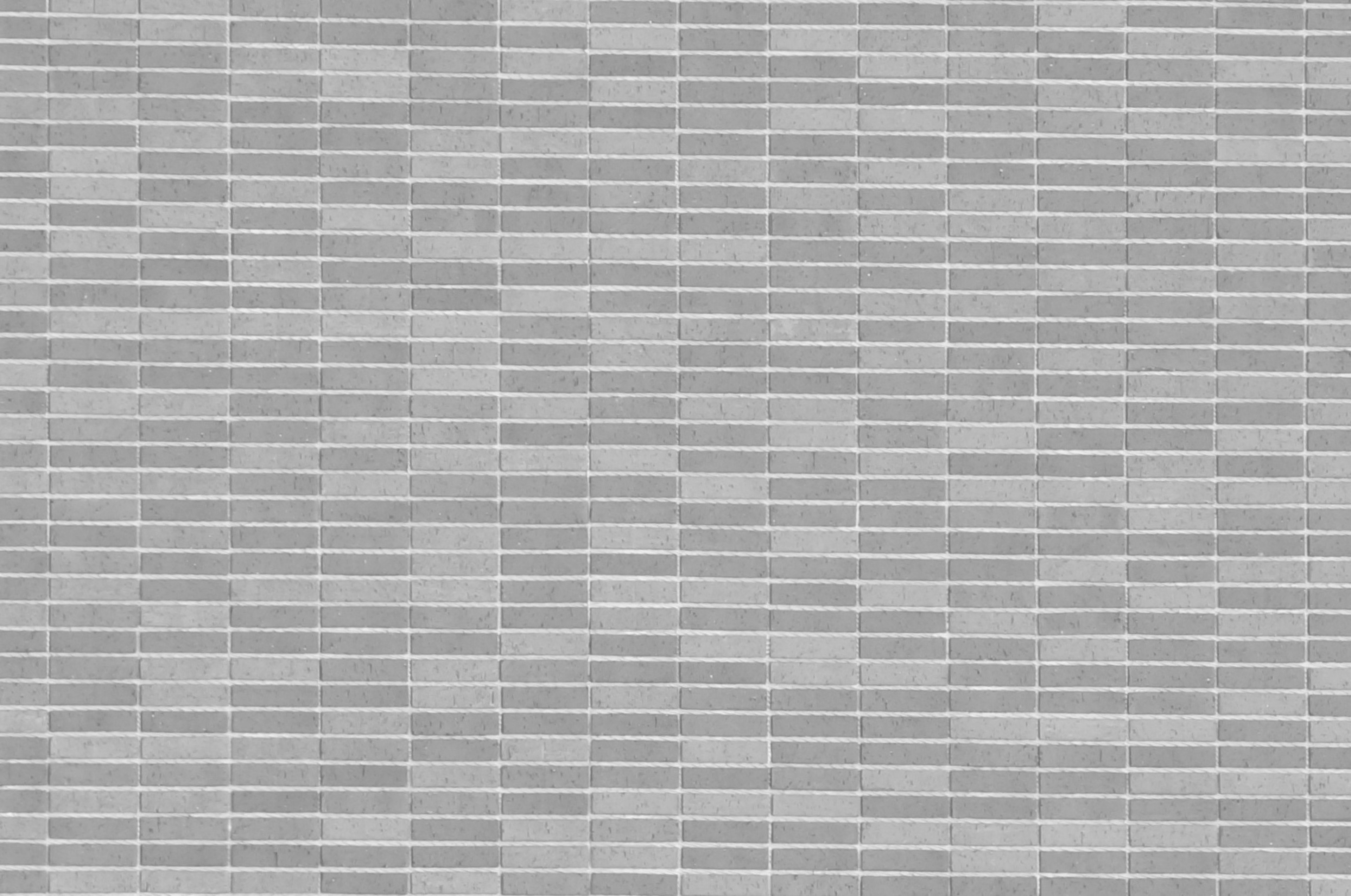 Gray tiled wall texture with uniform rectangular patterns