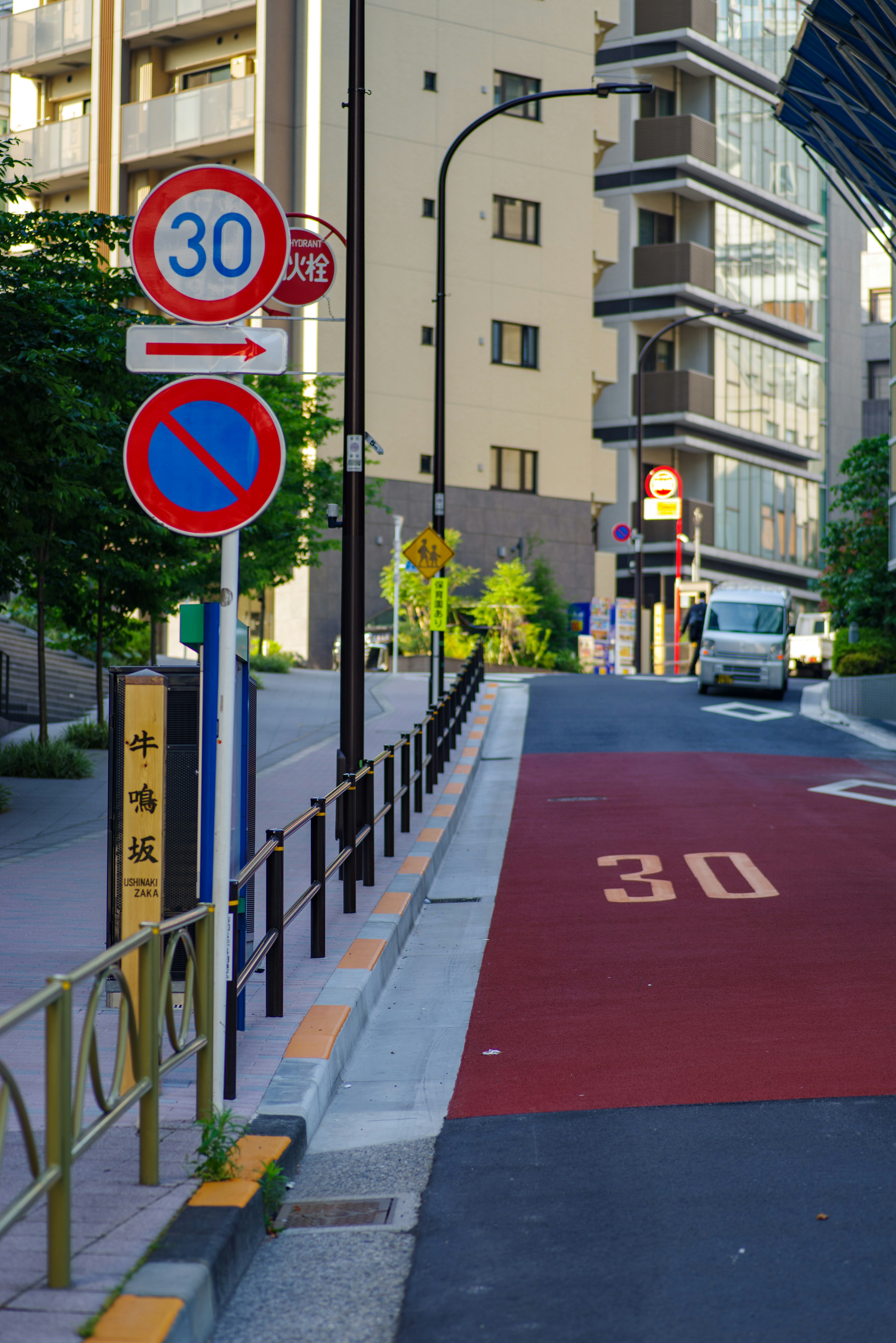 Urban scene with a 30 km/h speed limit sign on a red road