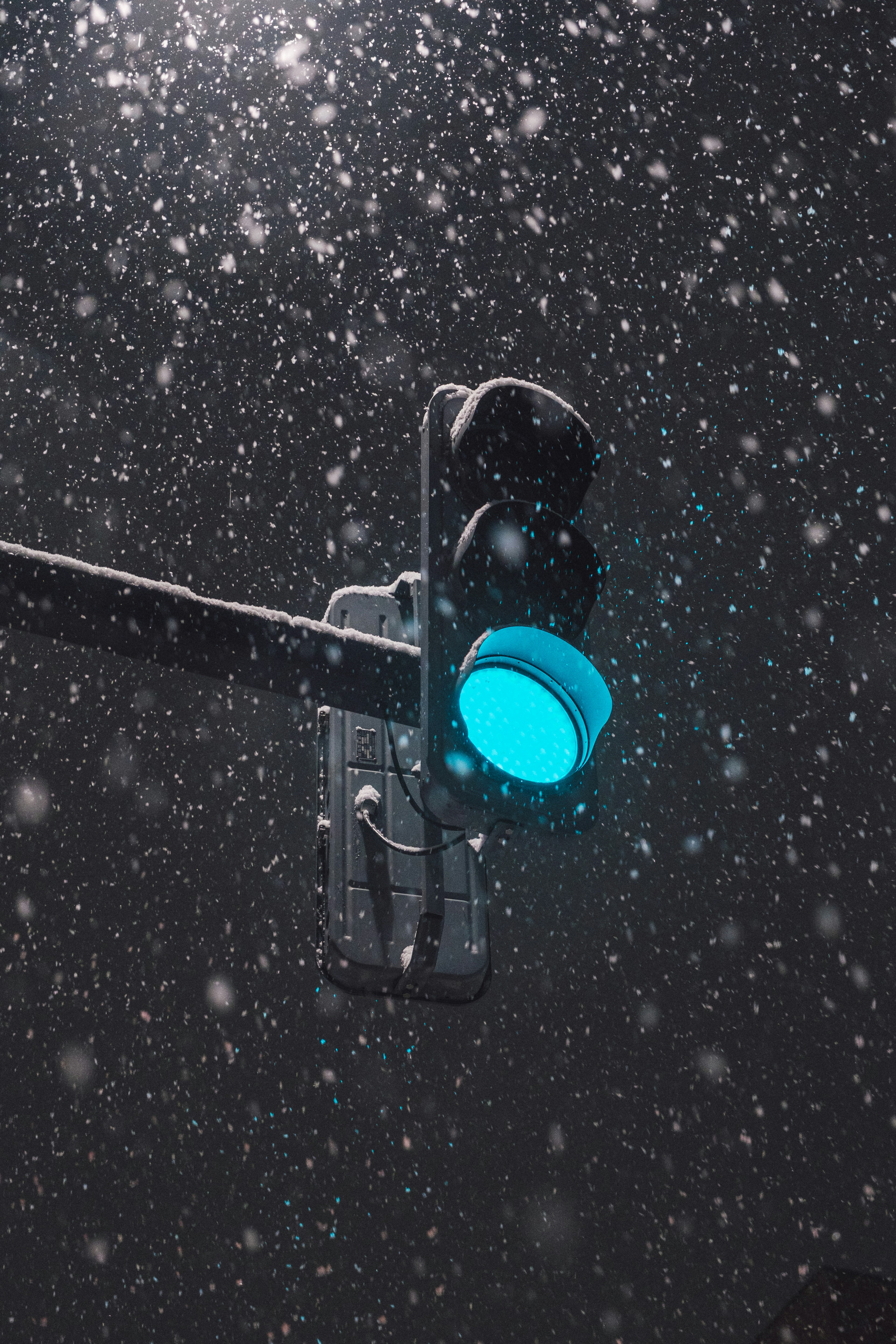 Traffic light showing green in a snowstorm