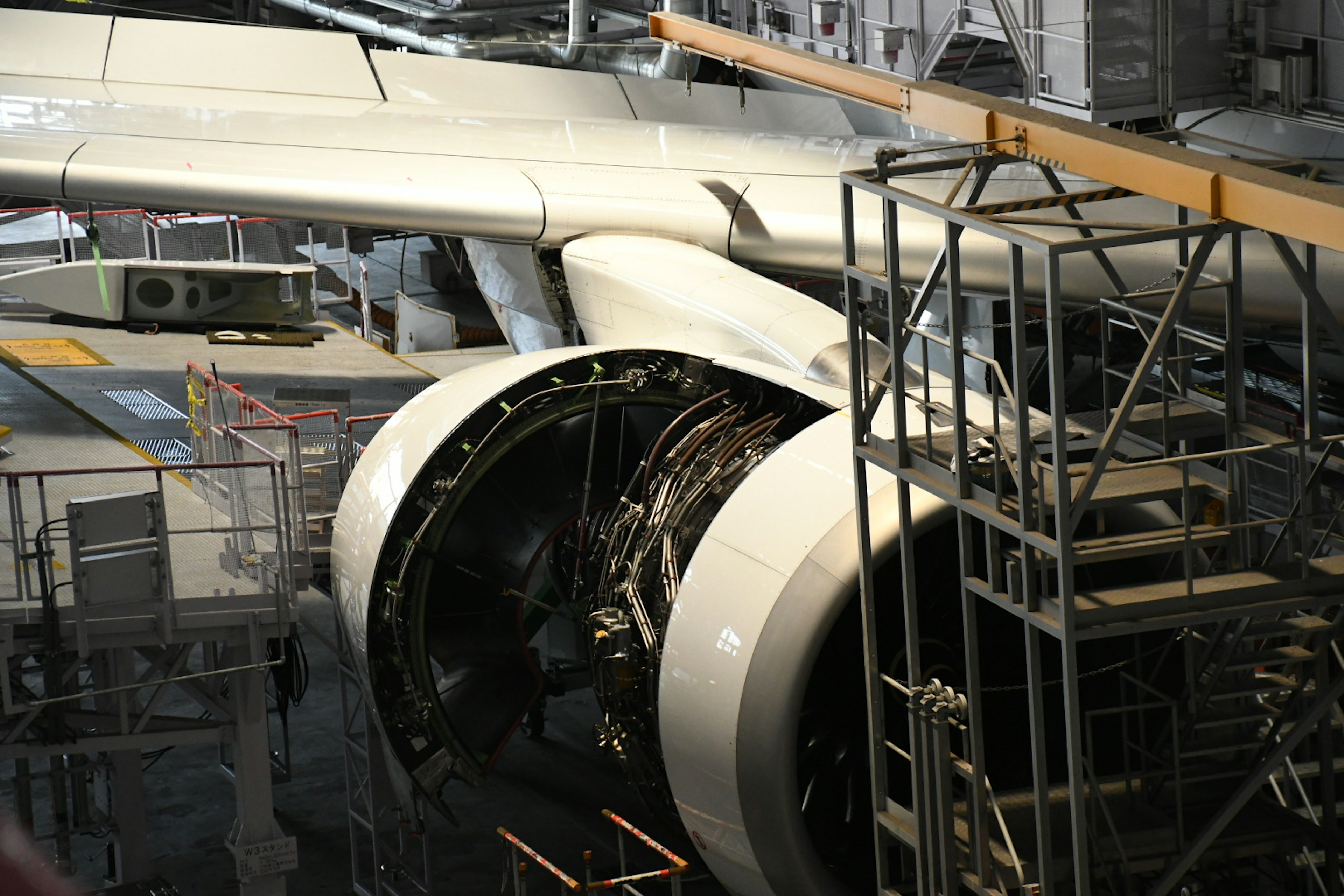 Aircraft engine under maintenance showcasing exposed structures and scaffolding