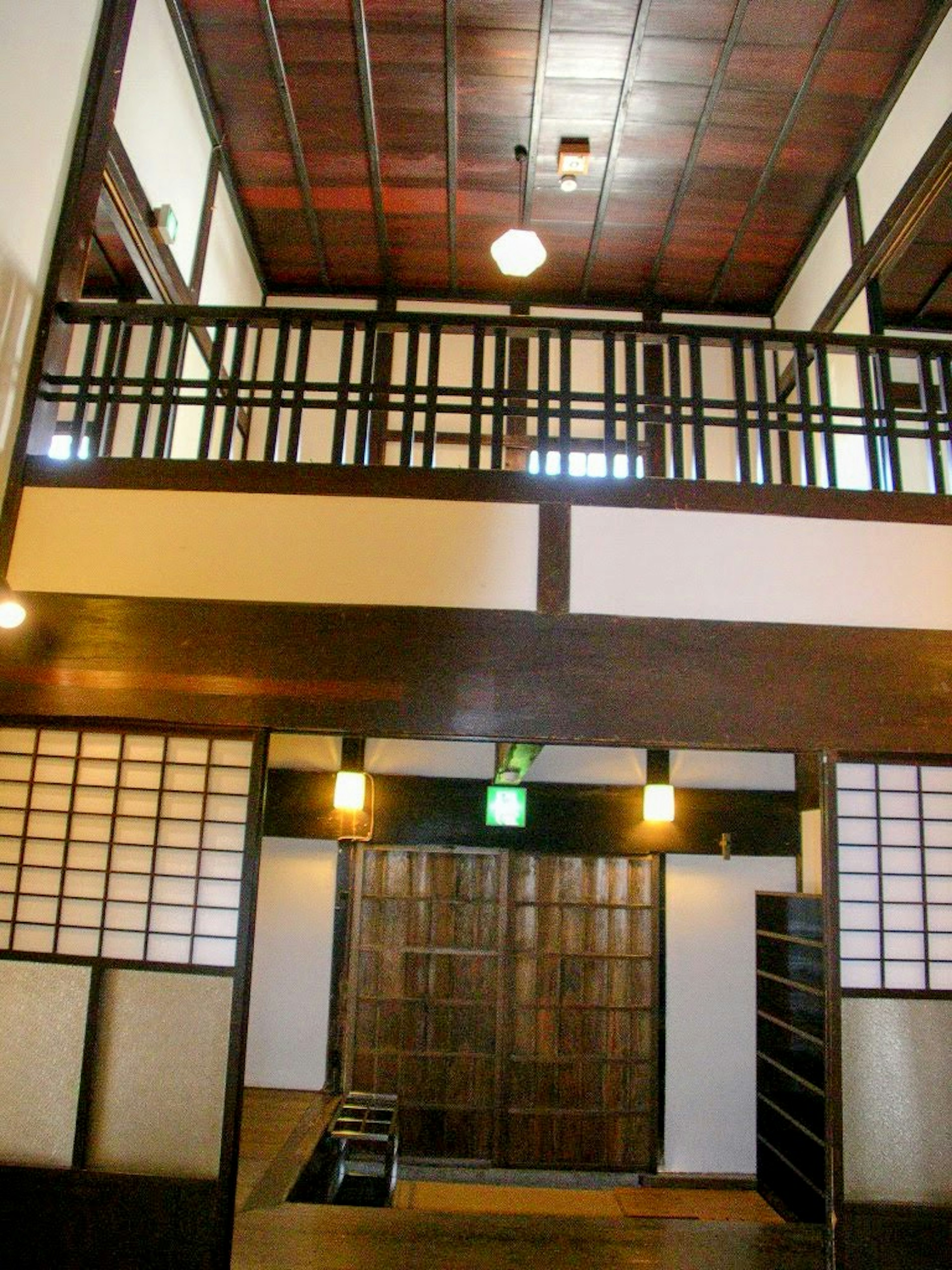 Interior of a traditional Japanese house with wooden balcony railing shoji screens and distinctive lighting