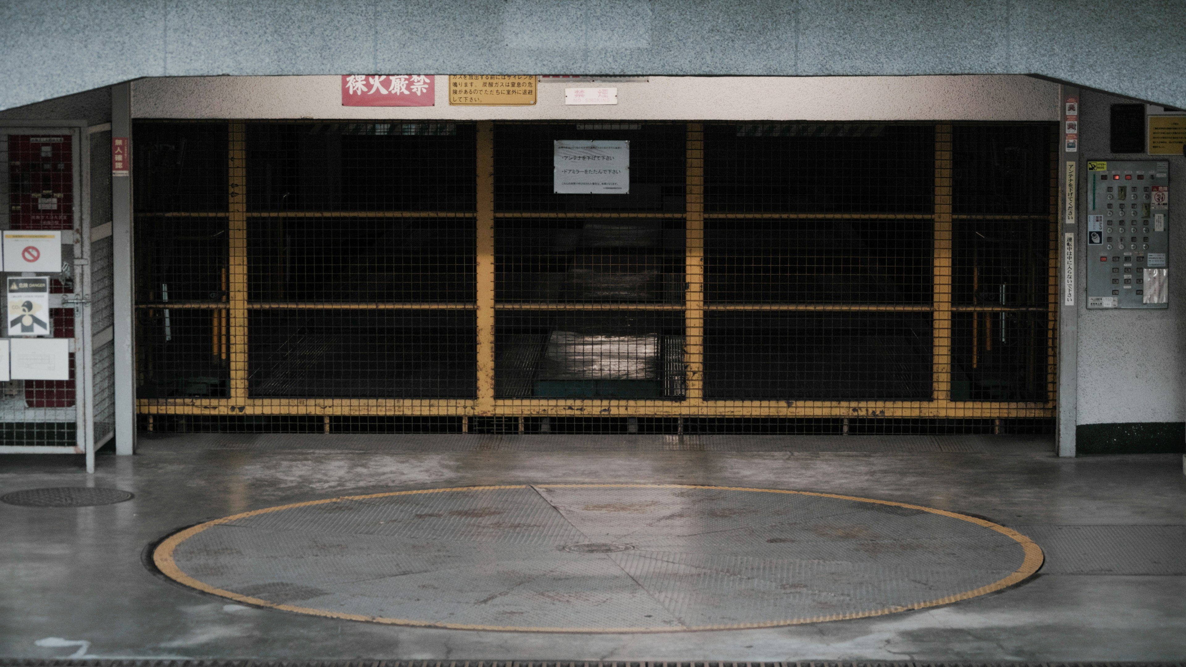 Empty parking area with a turntable and wooden shelves