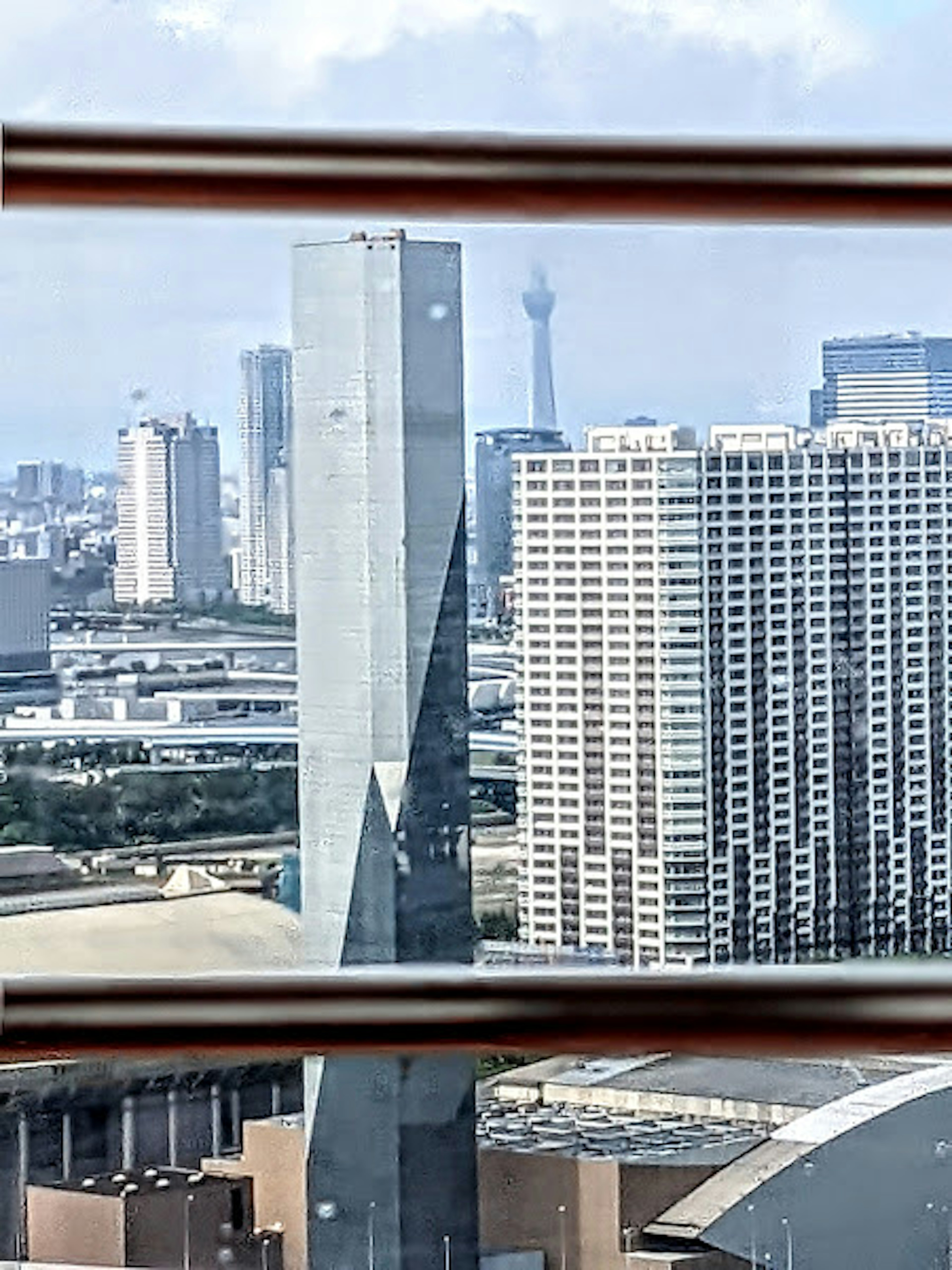 City skyline featuring modern skyscrapers and a distant tower