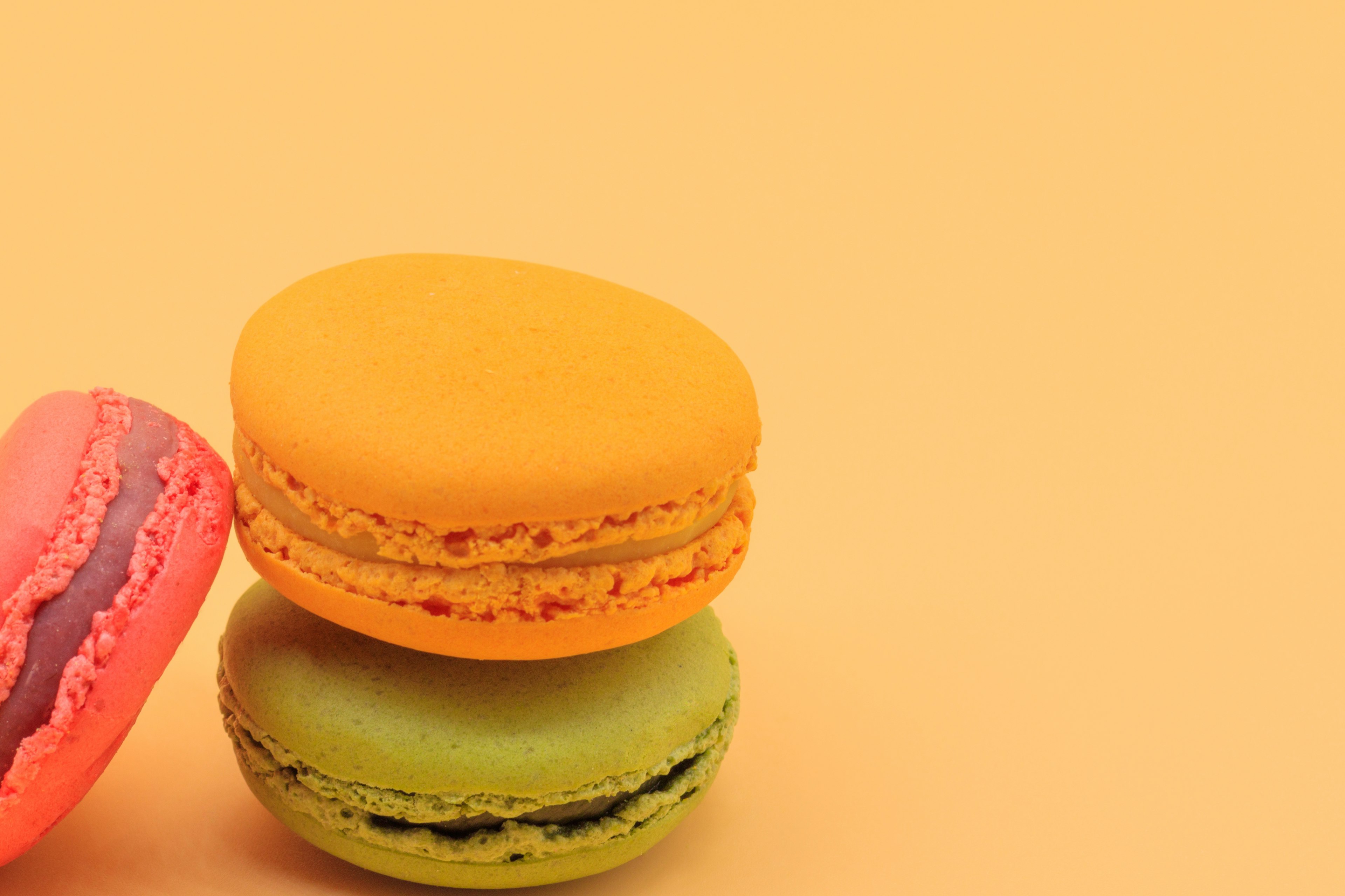 Colorful macarons on an orange background