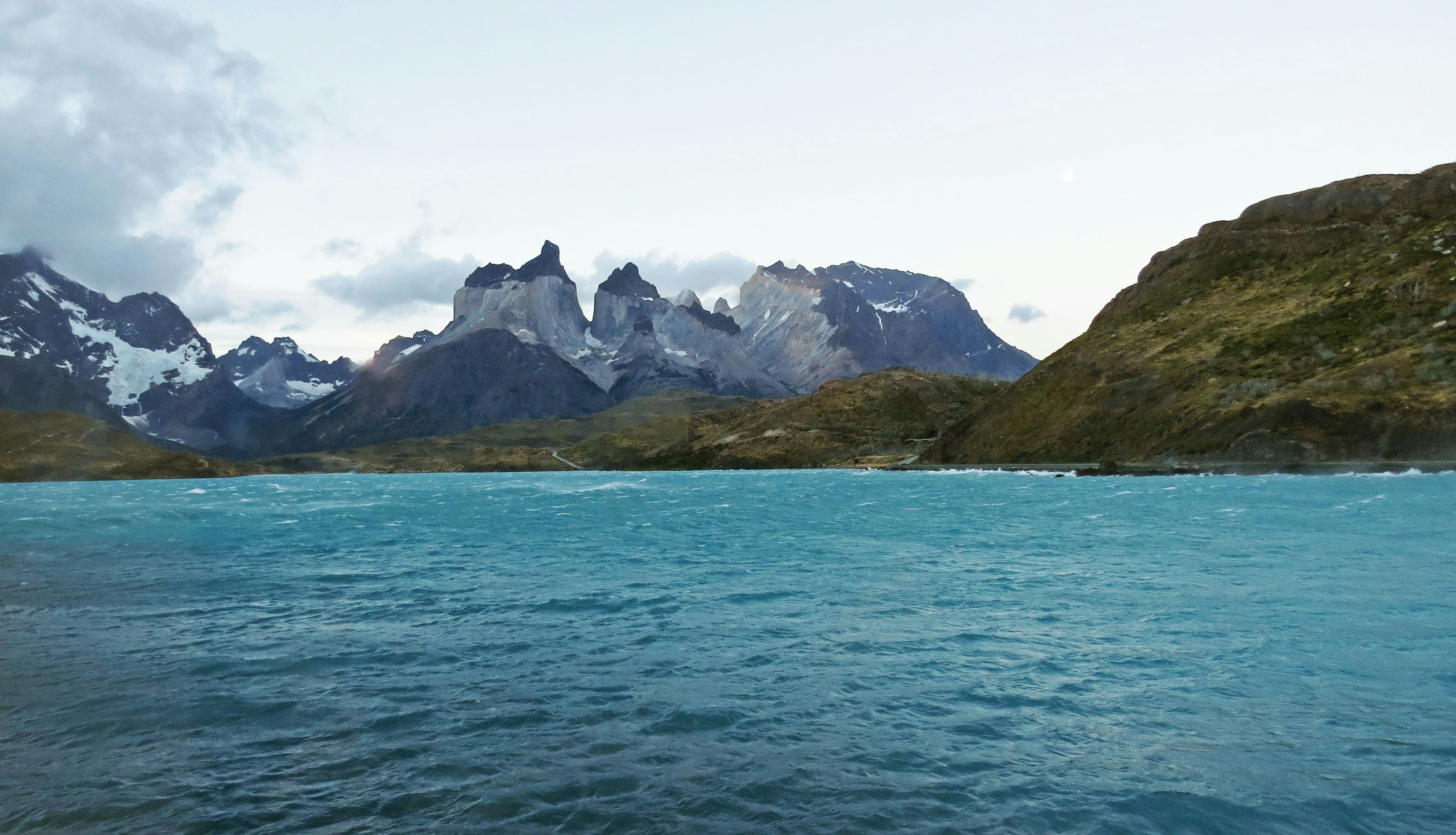 Scenic view of turquoise water and majestic mountains