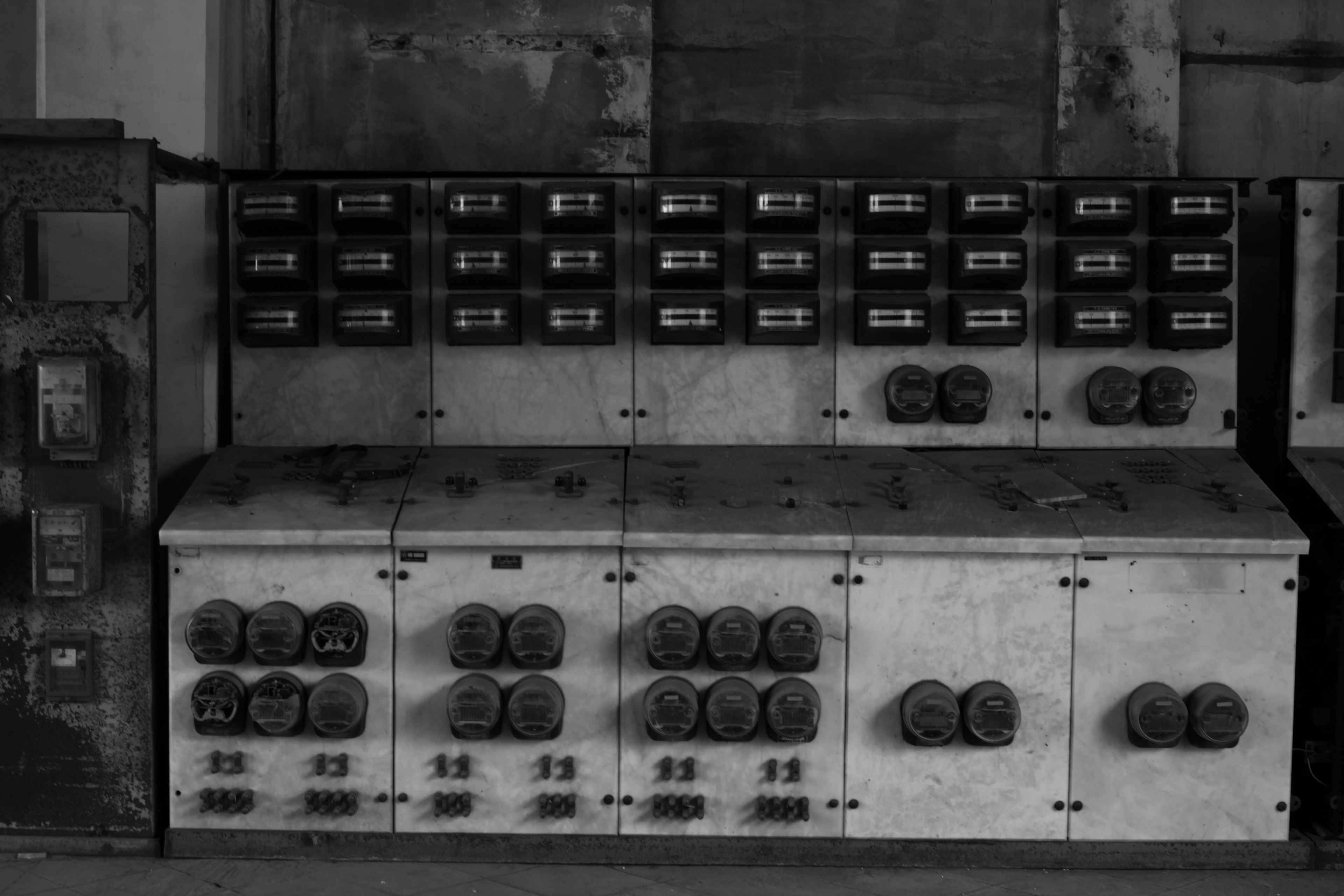 Image of an old control panel featuring numerous switches and dials