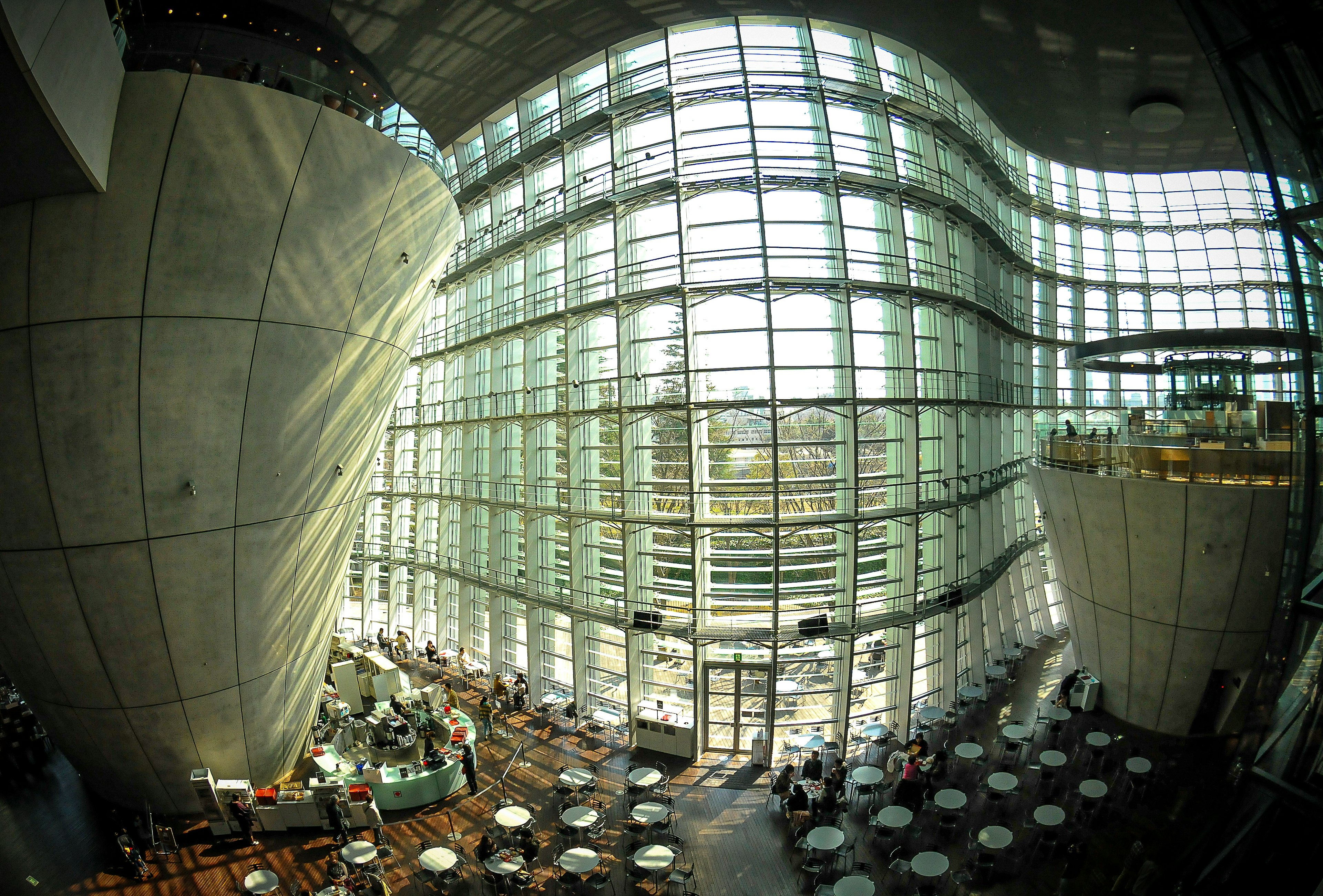 Interior of a modern building with large glass walls and curved structures