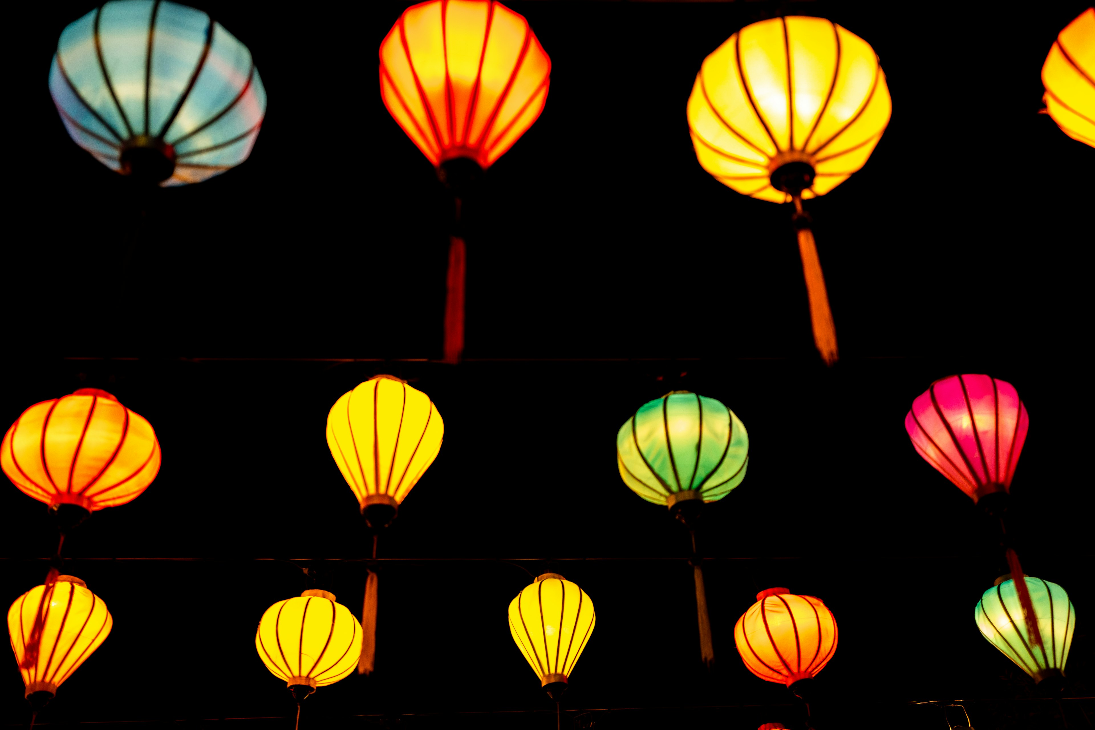 Colorful lanterns hanging in a night setting