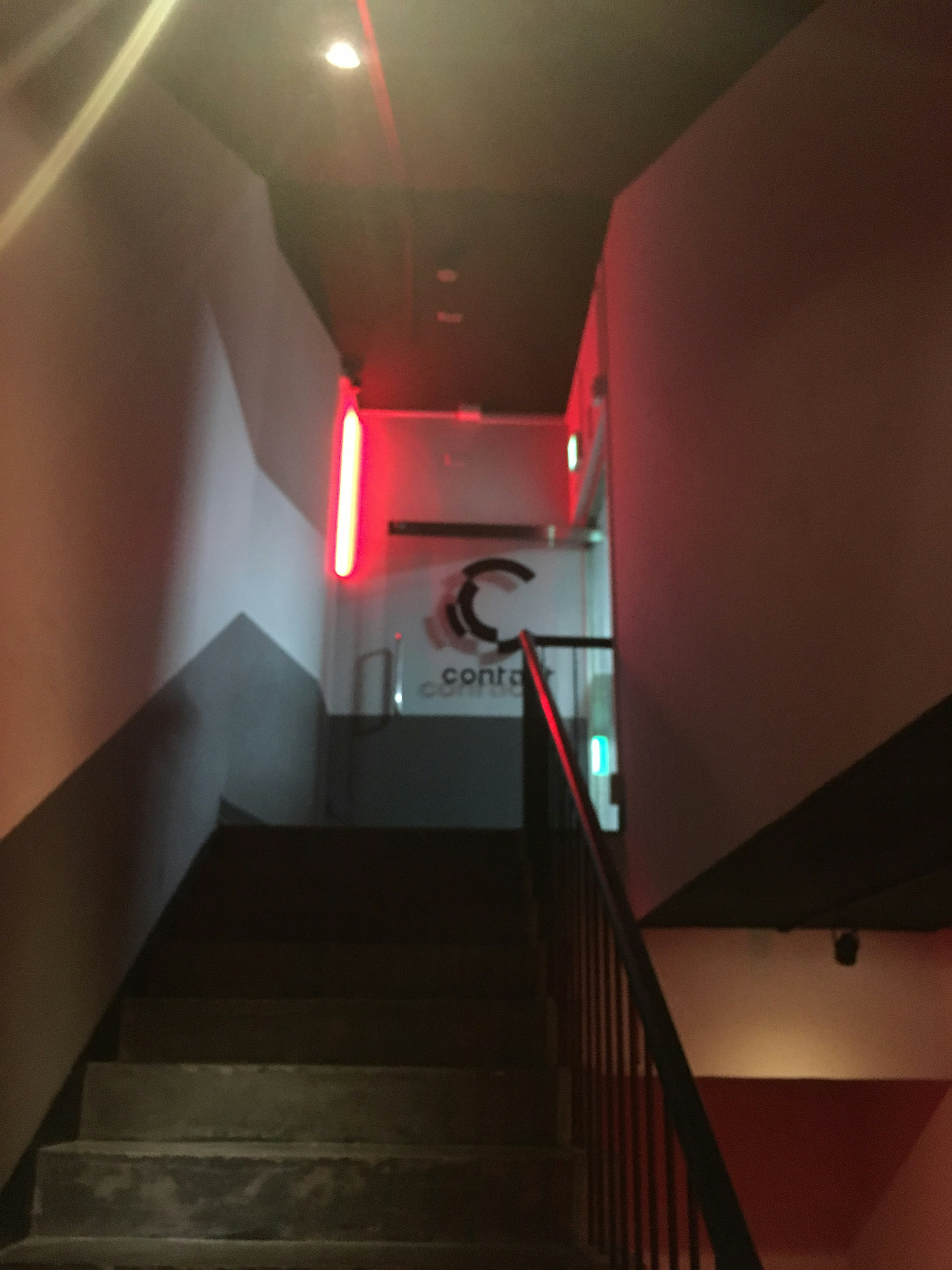 Stairs with red lighting and visible café logo