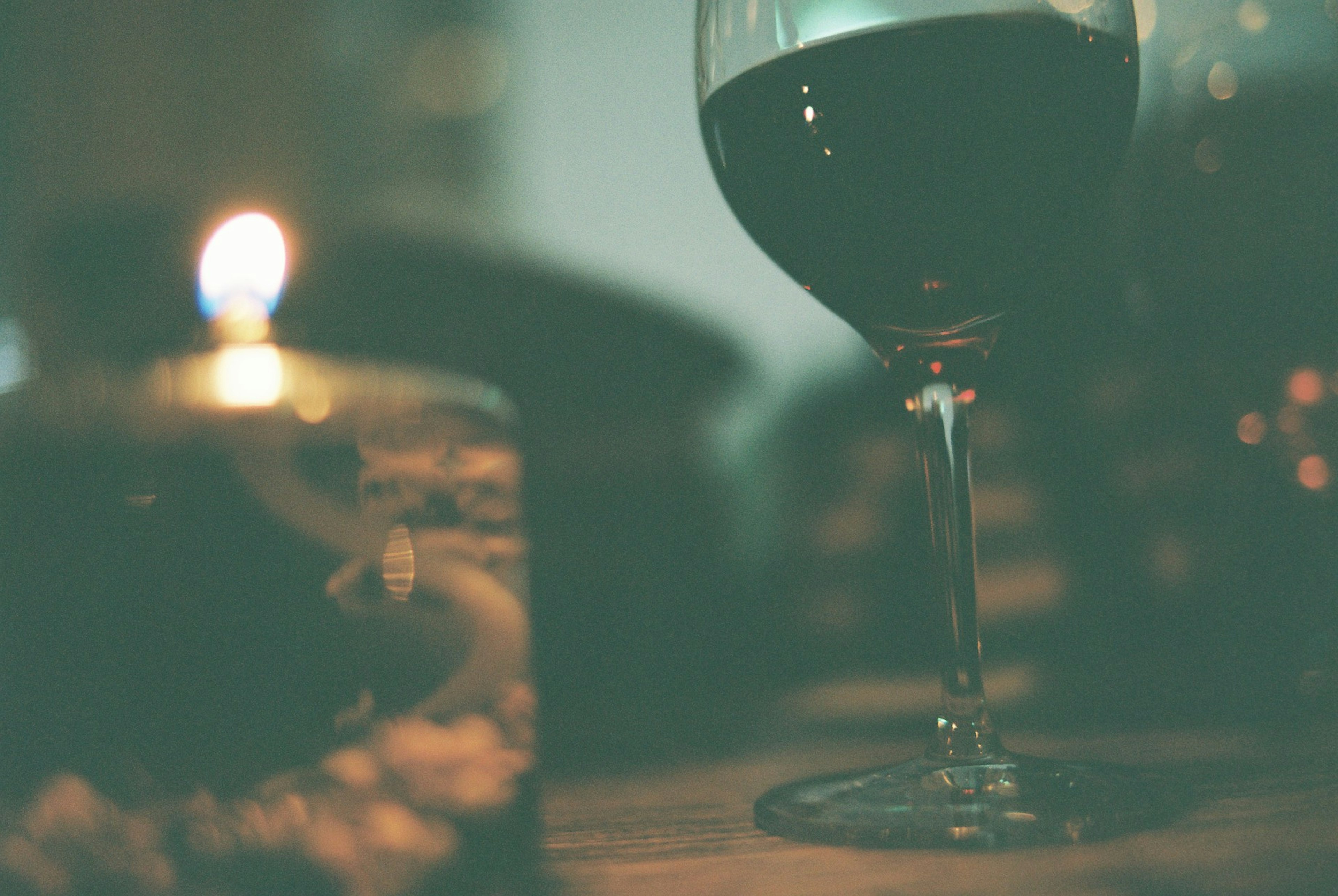 Glass of red wine with soft candlelight