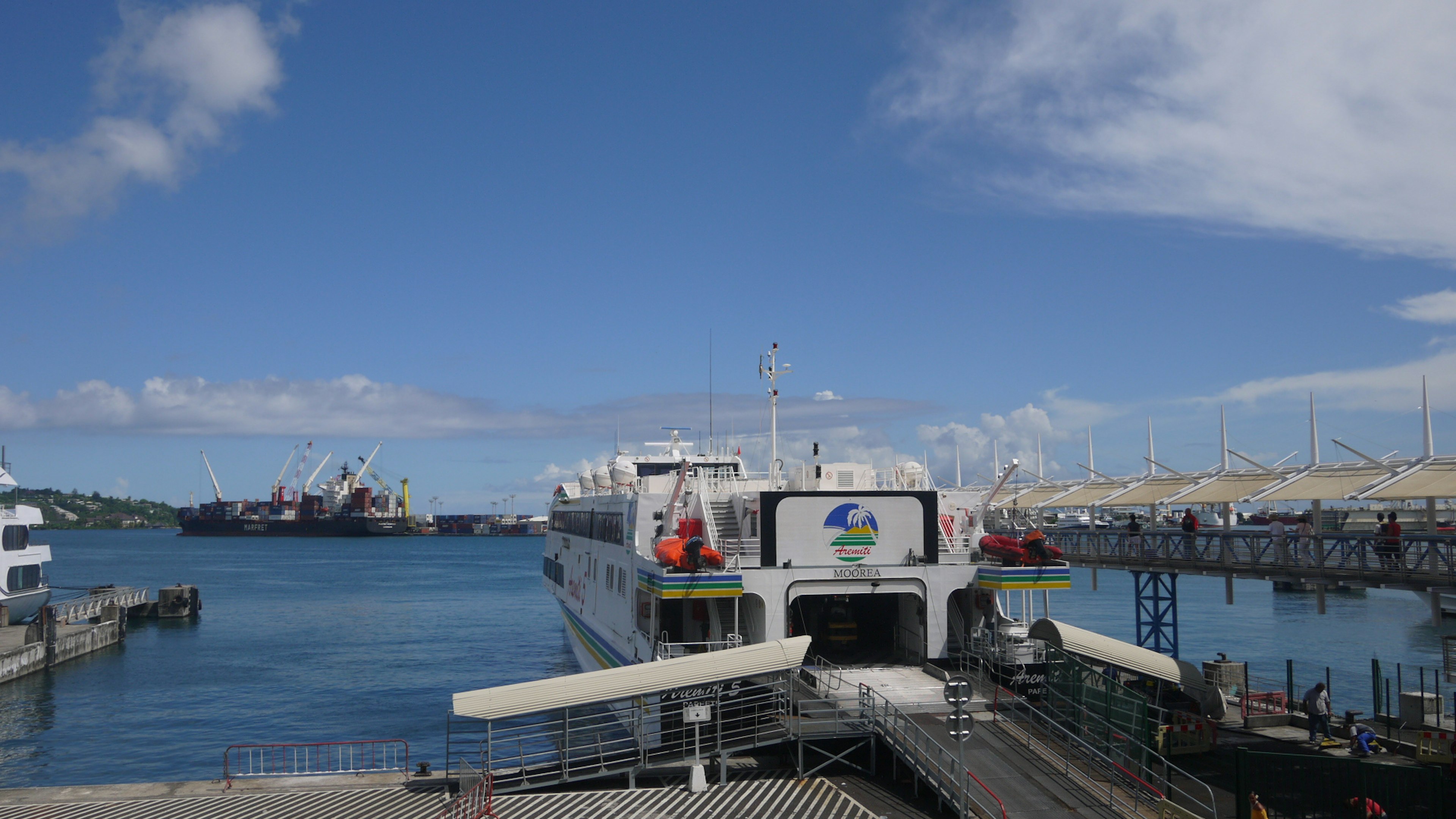 Ferry docked at a port with blue sky