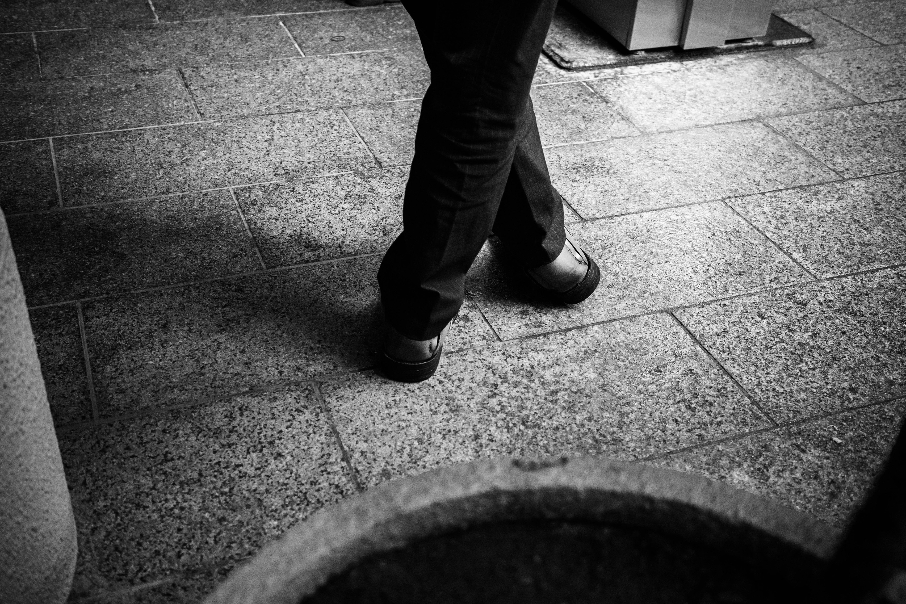 Black and white image of a person's feet walking