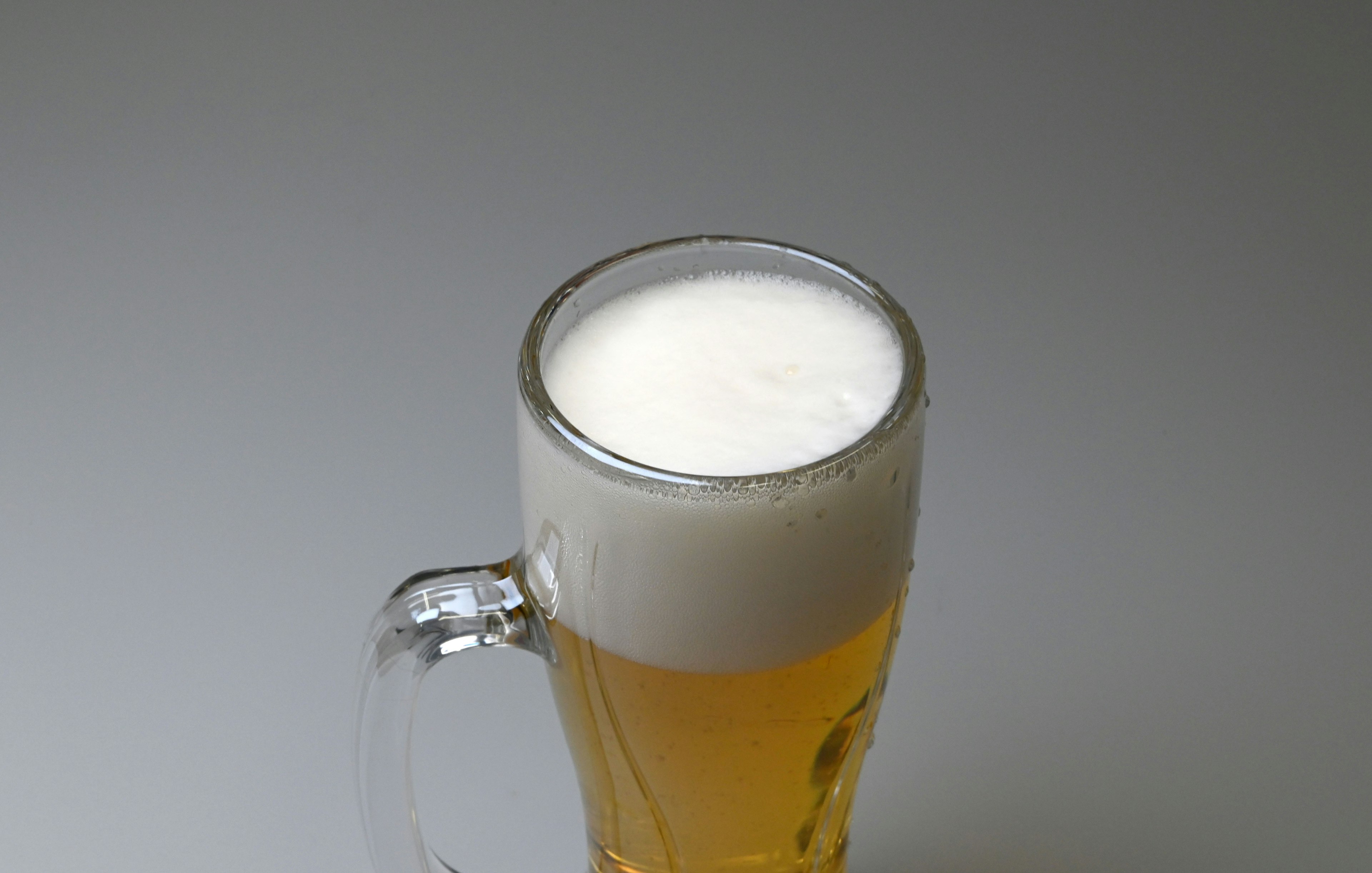 Top view of a beer glass with frothy head