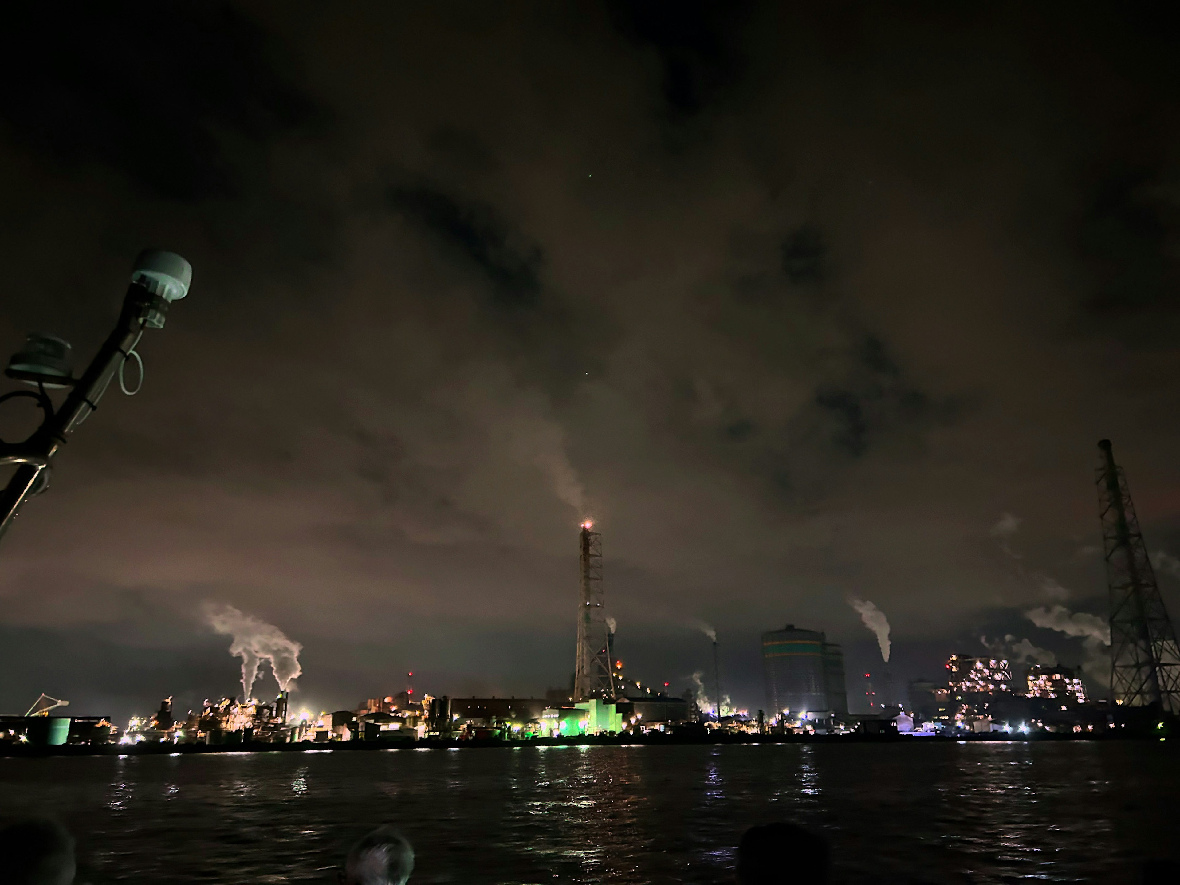 Night view of an industrial area with smokestacks and factory lights