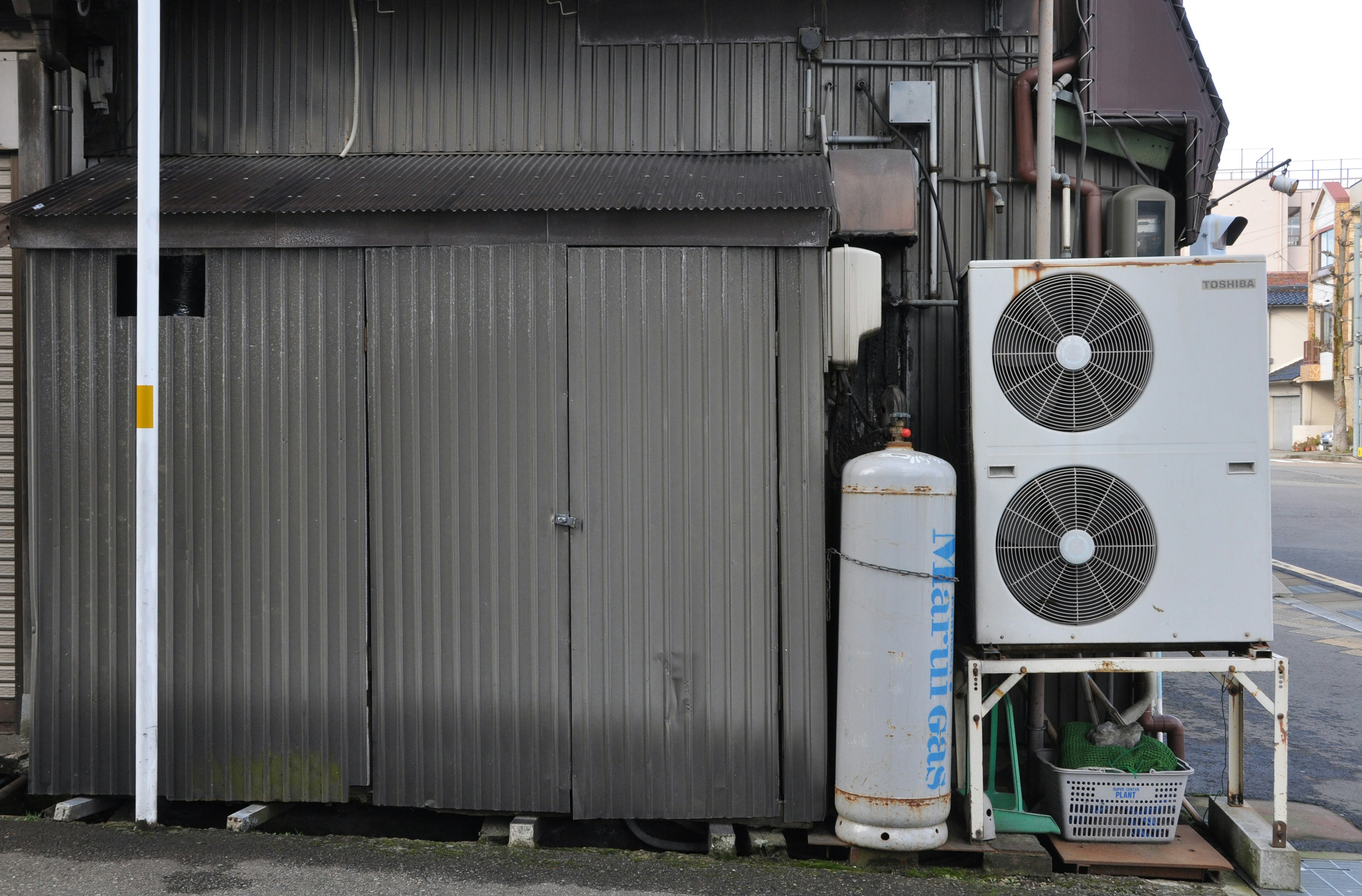 Metal shed with air conditioning unit and gas cylinder