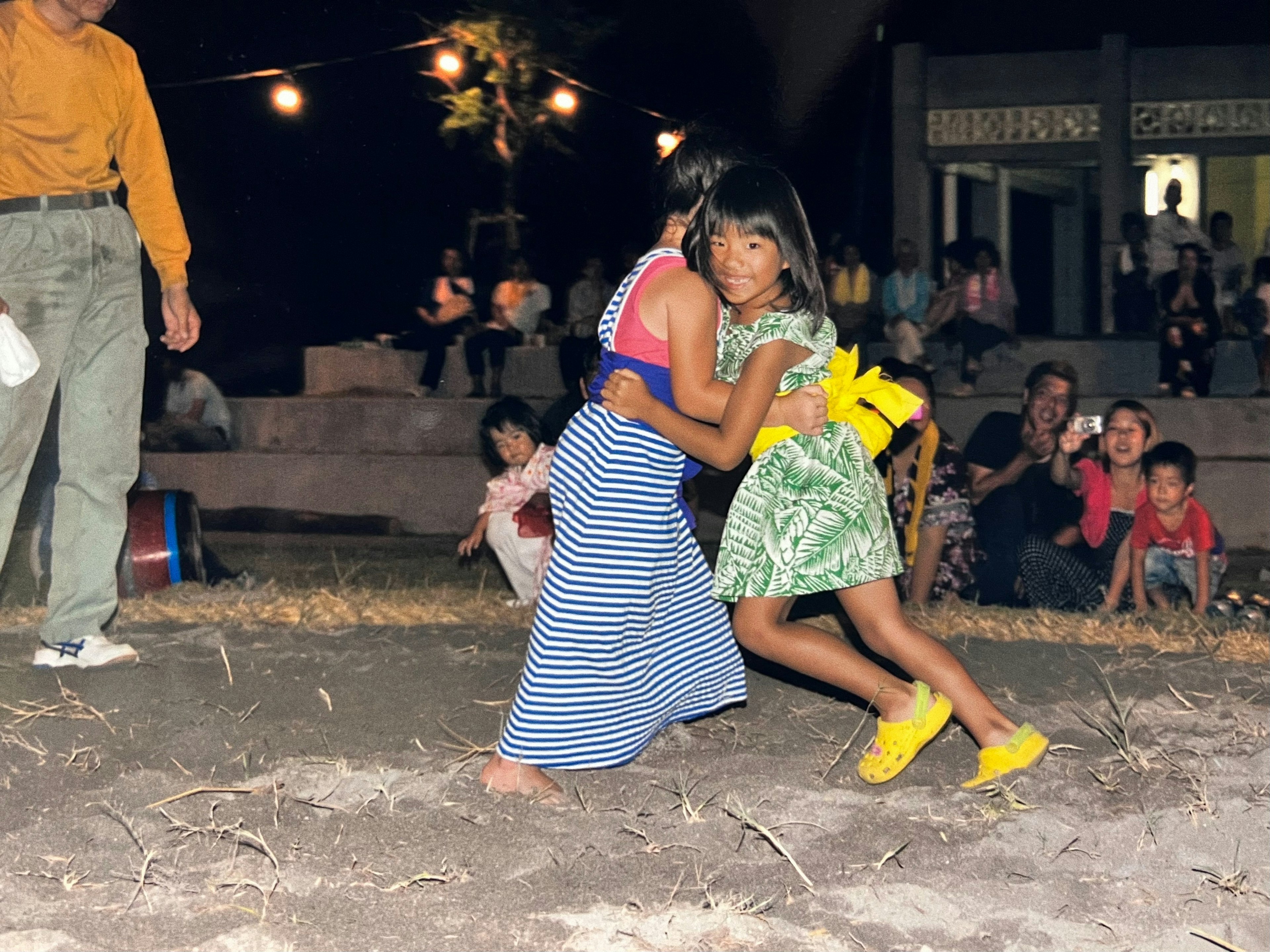 Children joyfully playing during a night festival