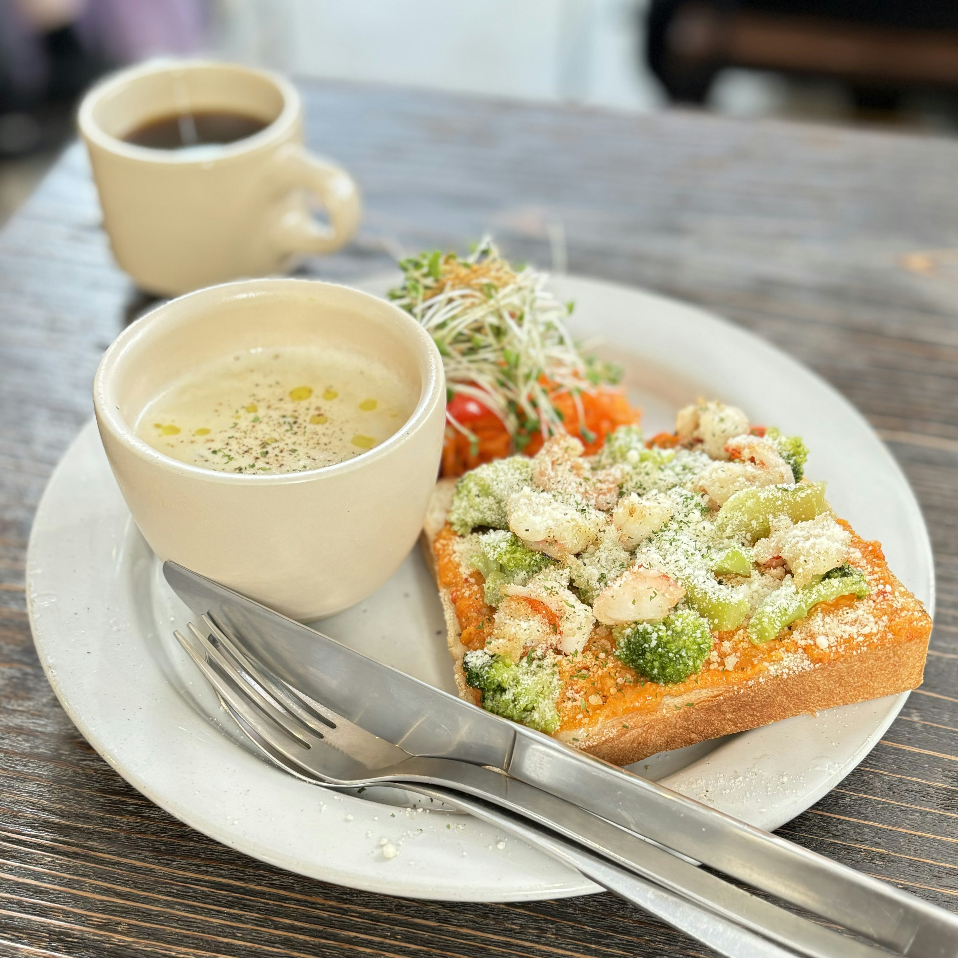 Delicious toast topped with vegetables and a side salad with coffee