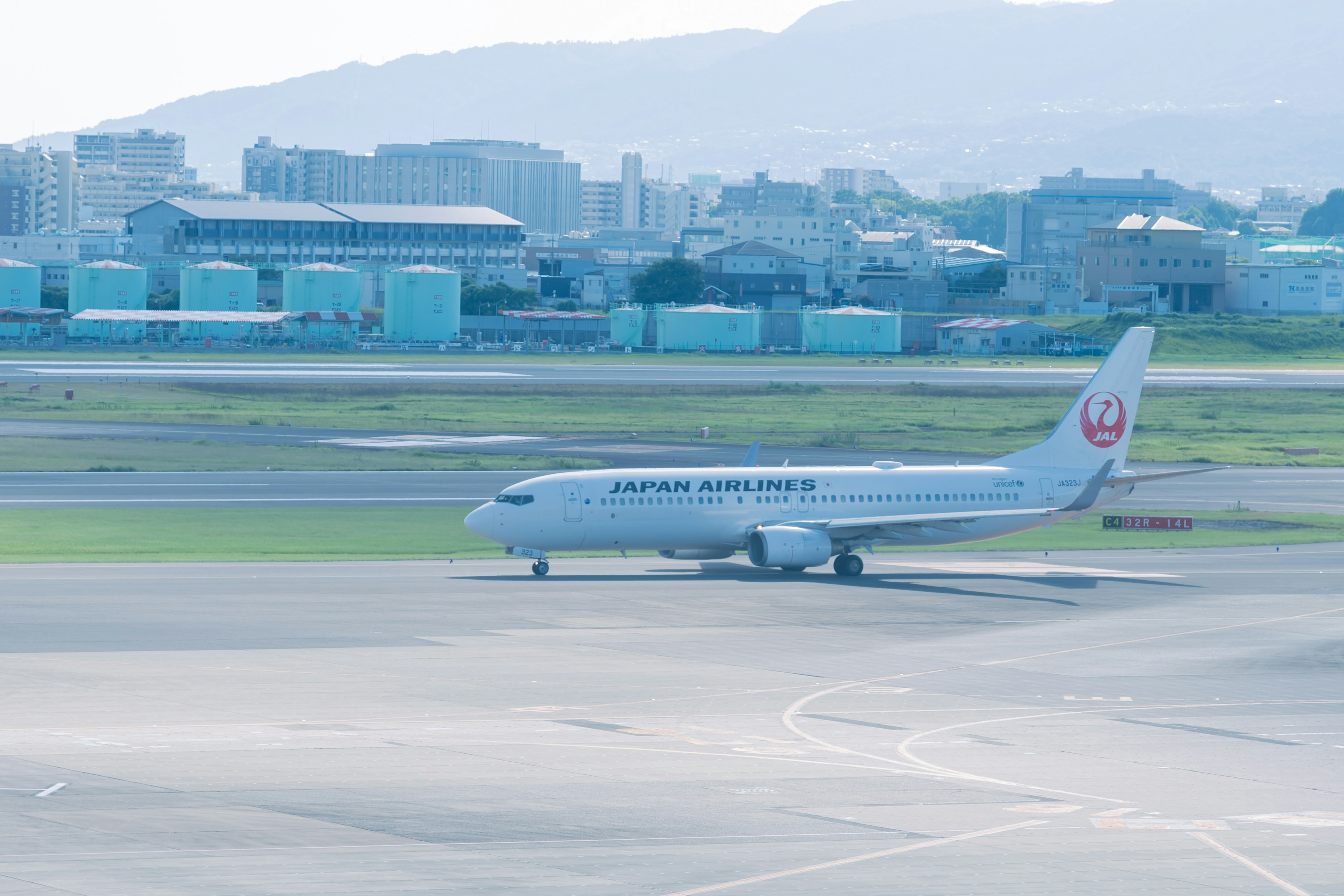 Japan Airlines airplane taxiing on the runway at an airport